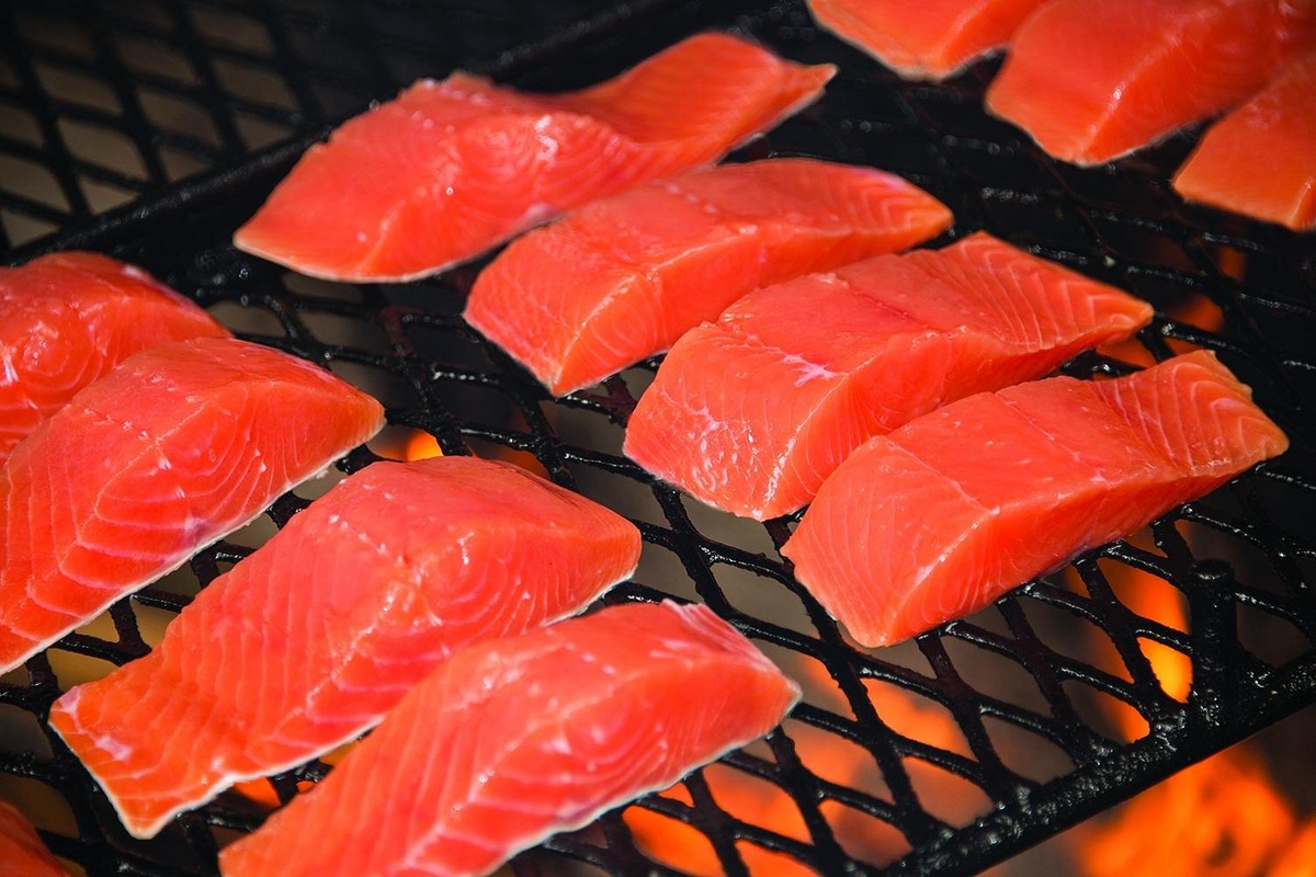 Salmon portions grilling over a fire at Gold Creek Salmon Bake