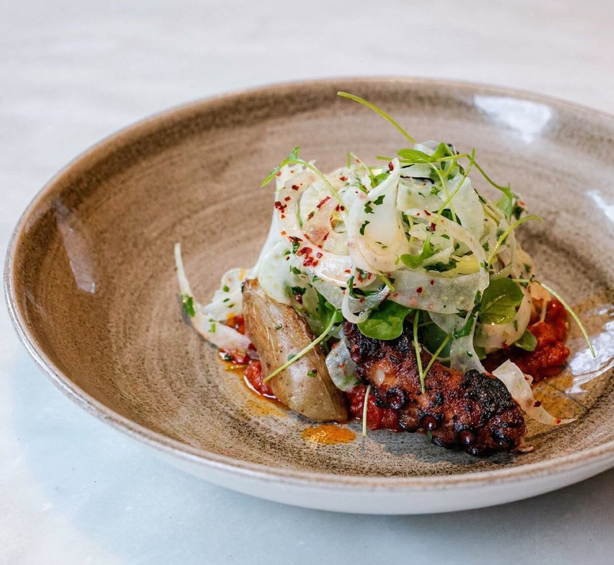 Charred octopus photographed at Saltie Girl in Boston