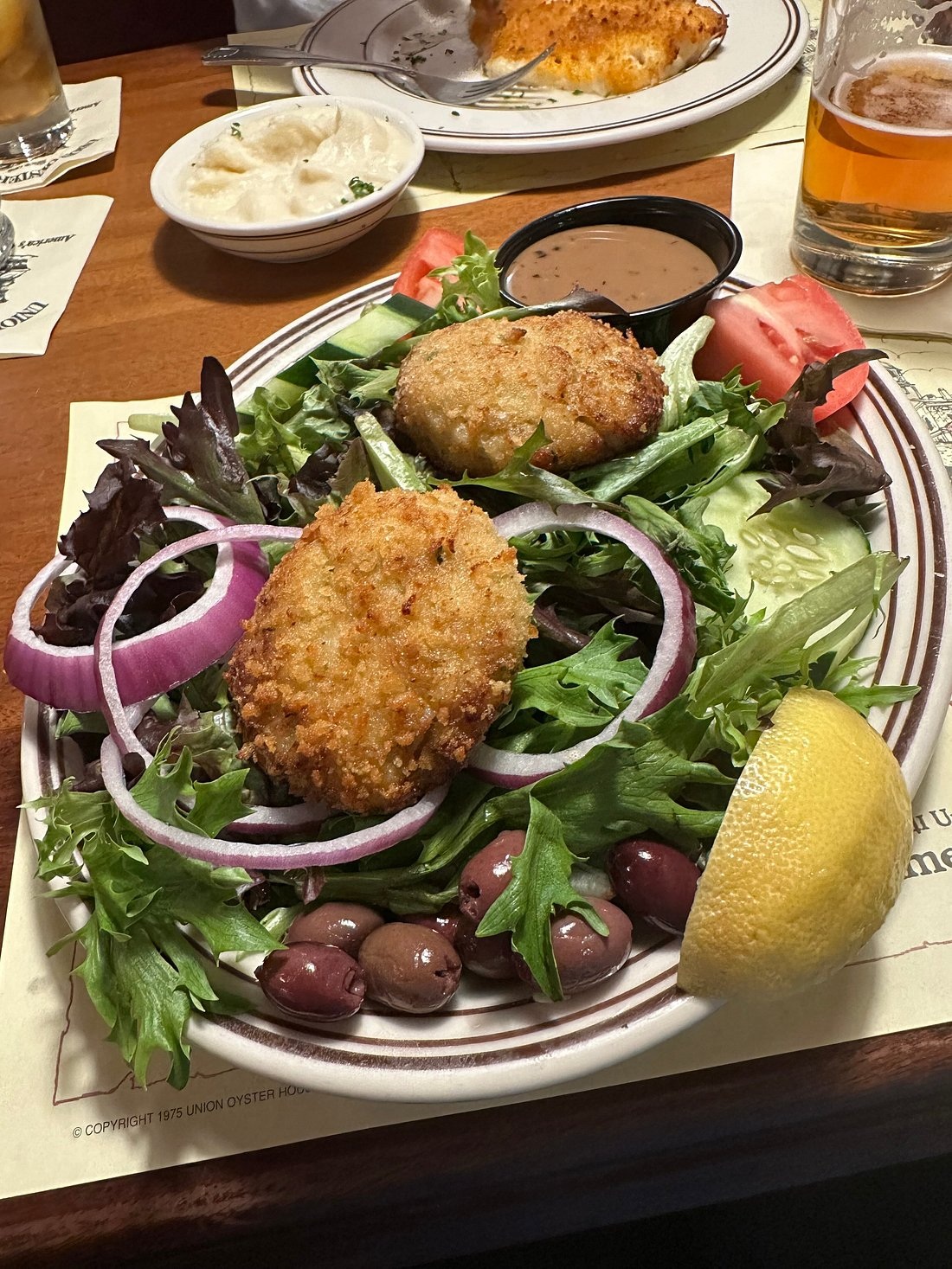 Crab cakes and mixed greens photographed at Union Oyster House