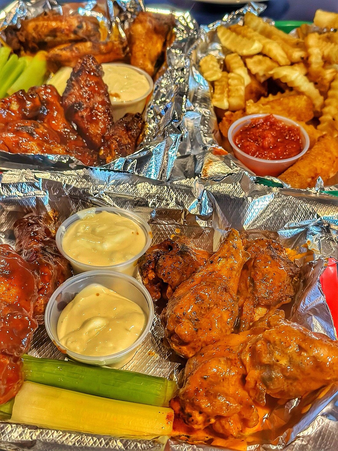Two foil-lined baskets of wings at Elmo’s