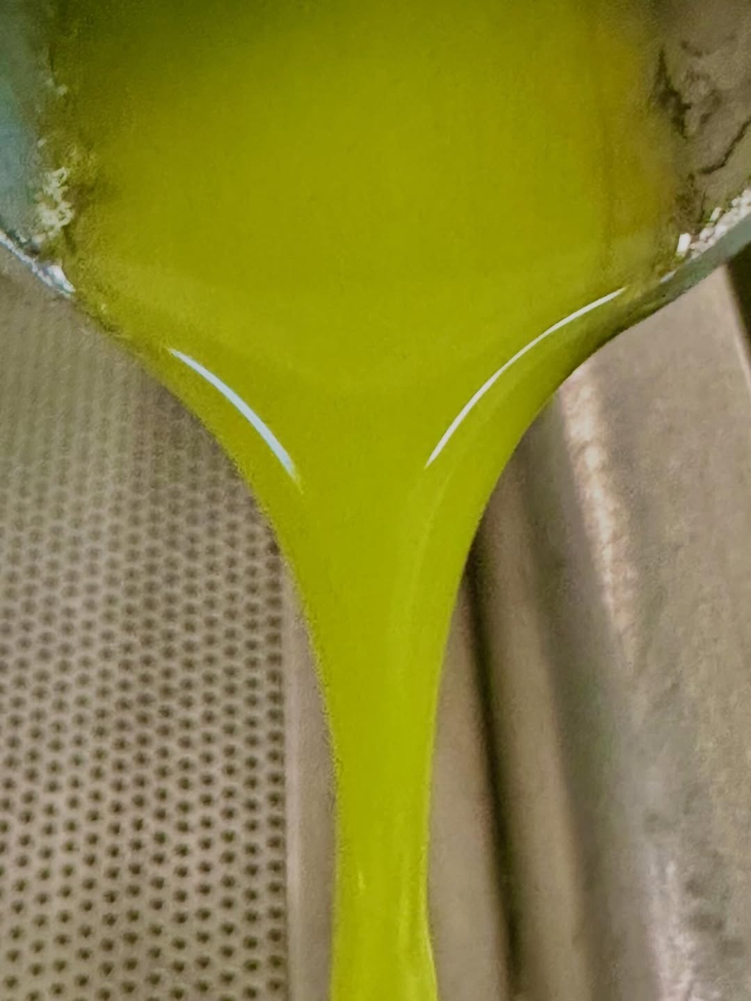 Fresh green olio nuovo flowing at Ojai Olive Oil during harvest