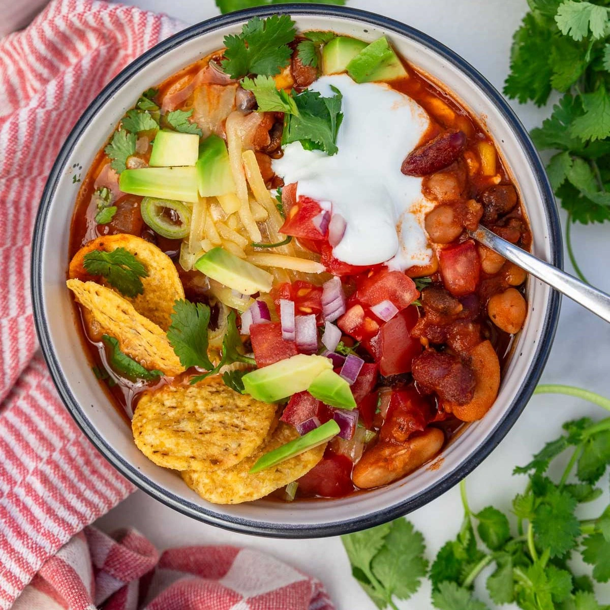 Bean chili served with tortilla chips and fresh toppings