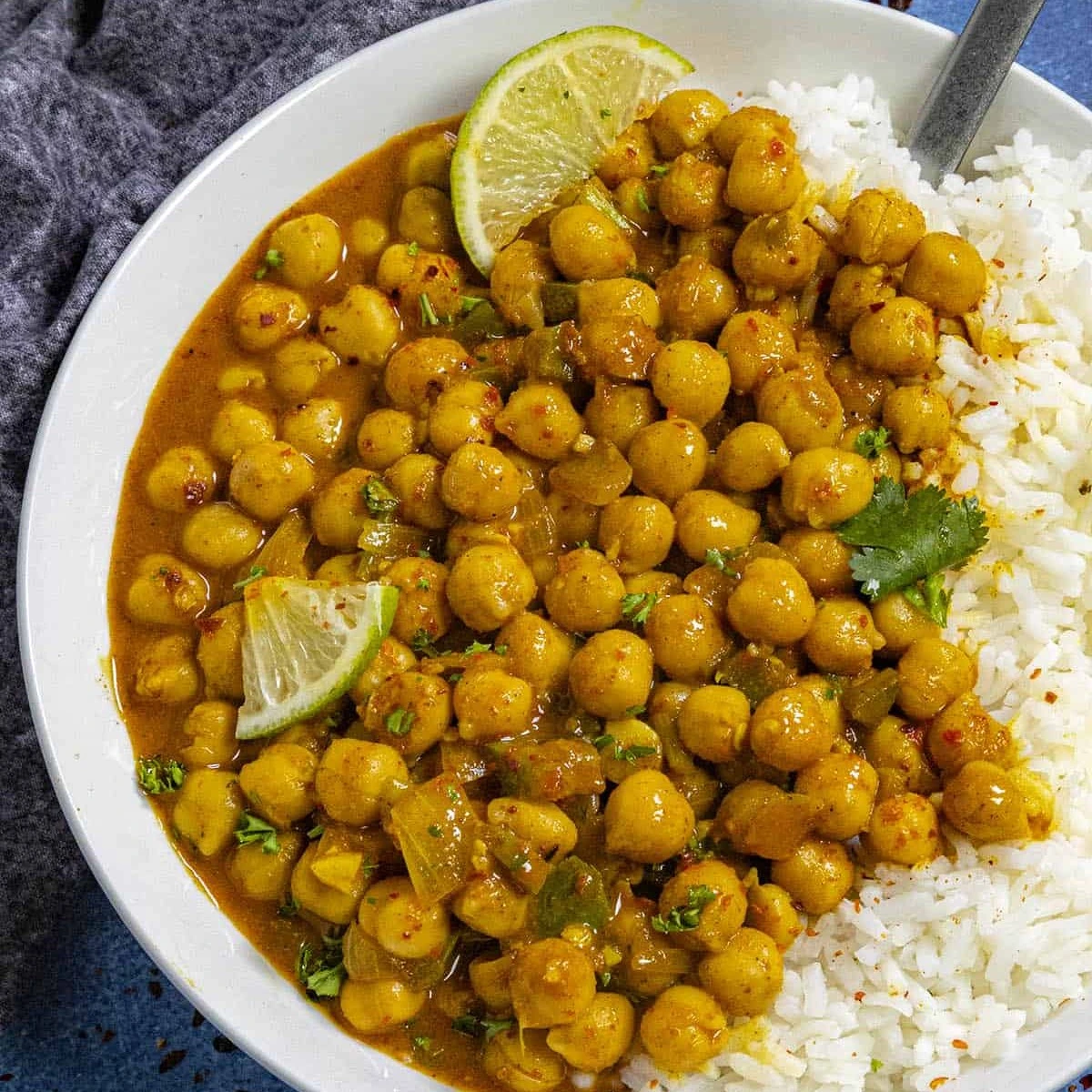 Chickpea curry served with rice and lime