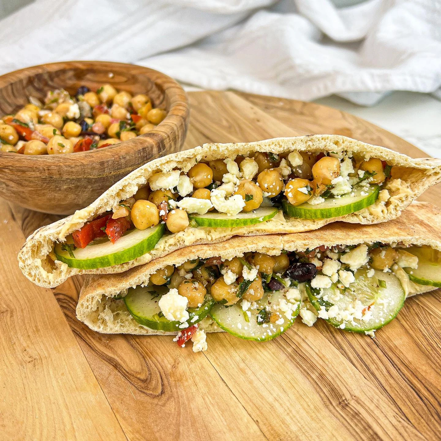 Hummus pita pockets filled with cucumber, chickpea salad, and feta