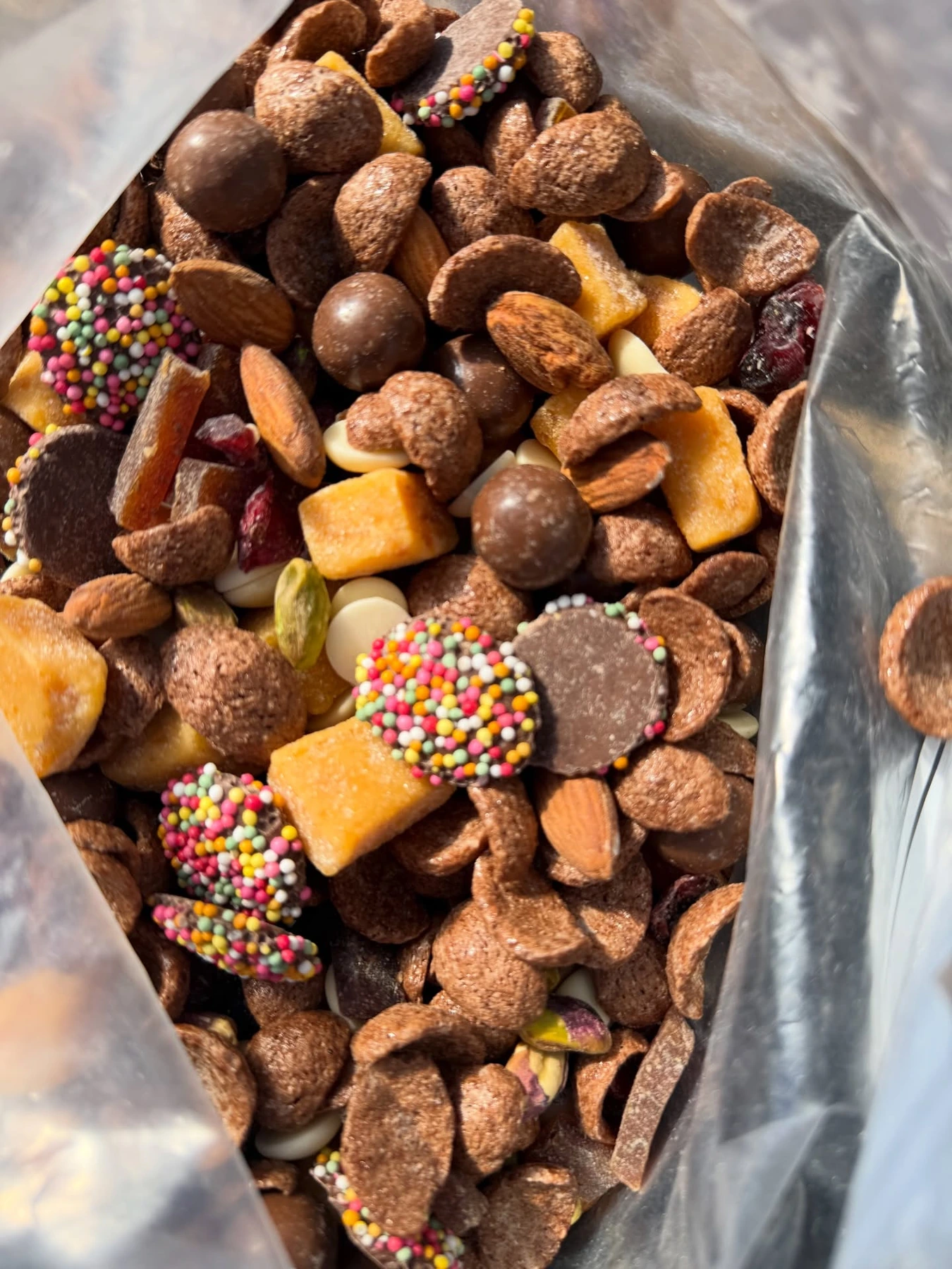 Trail mix with nuts, dried fruit, crunchy snacks, and chocolate