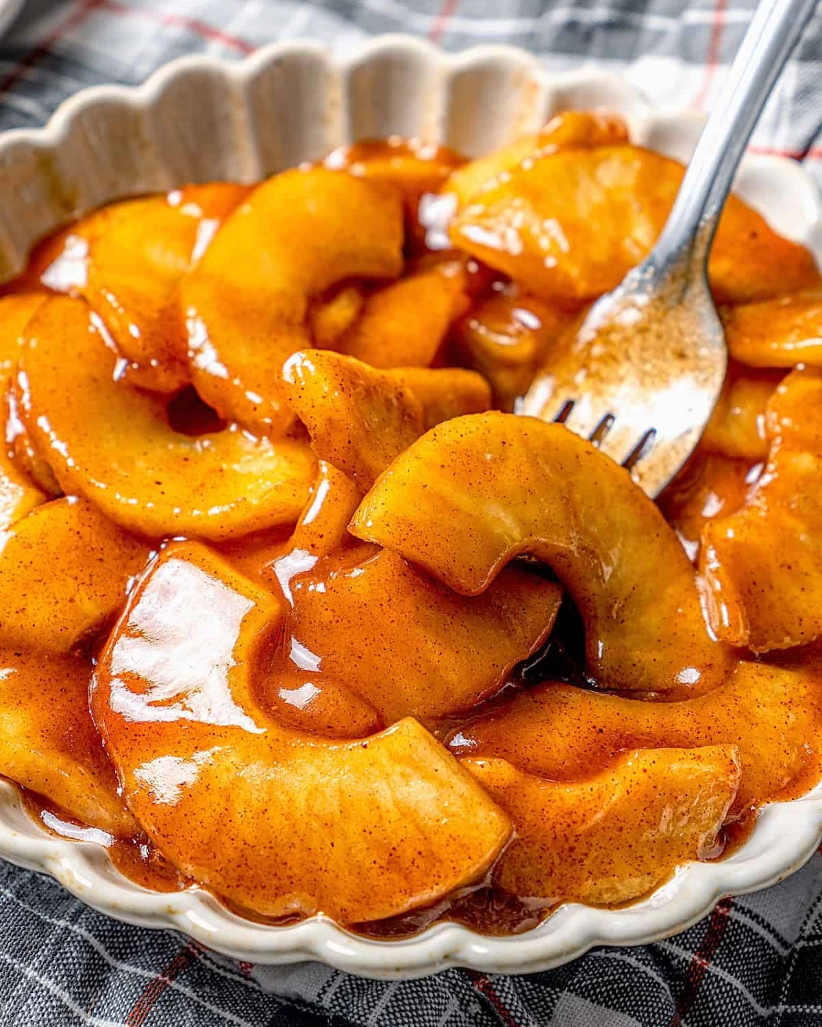 Warm sliced apples coated in cinnamon sauce