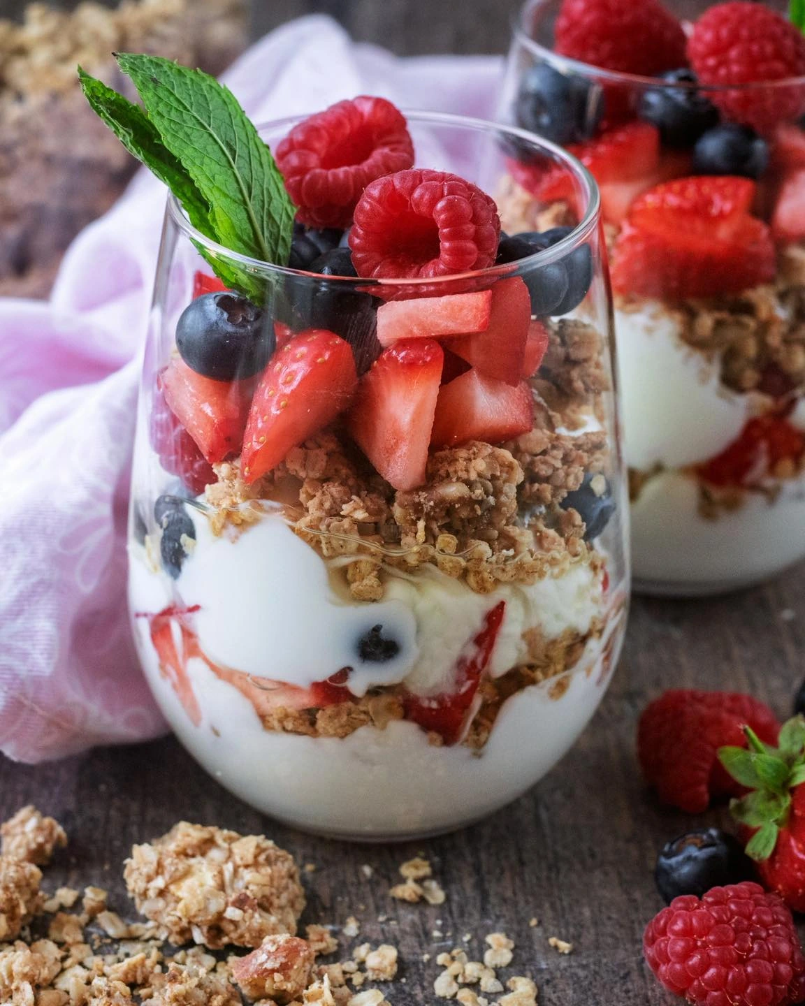 Greek yogurt, granola and mixed berries layered in glasses