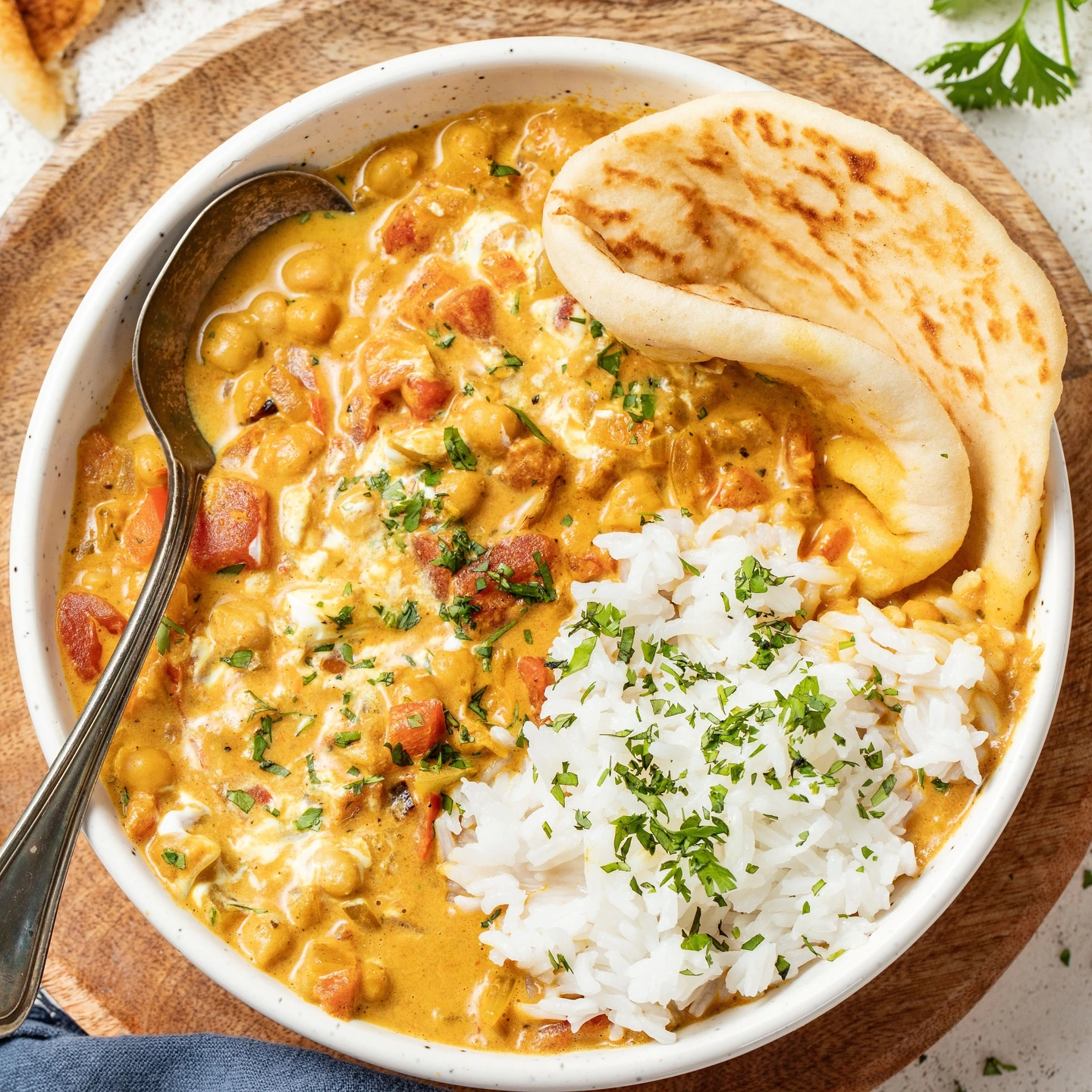 Creamy coconut chickpea curry served with rice and flatbread