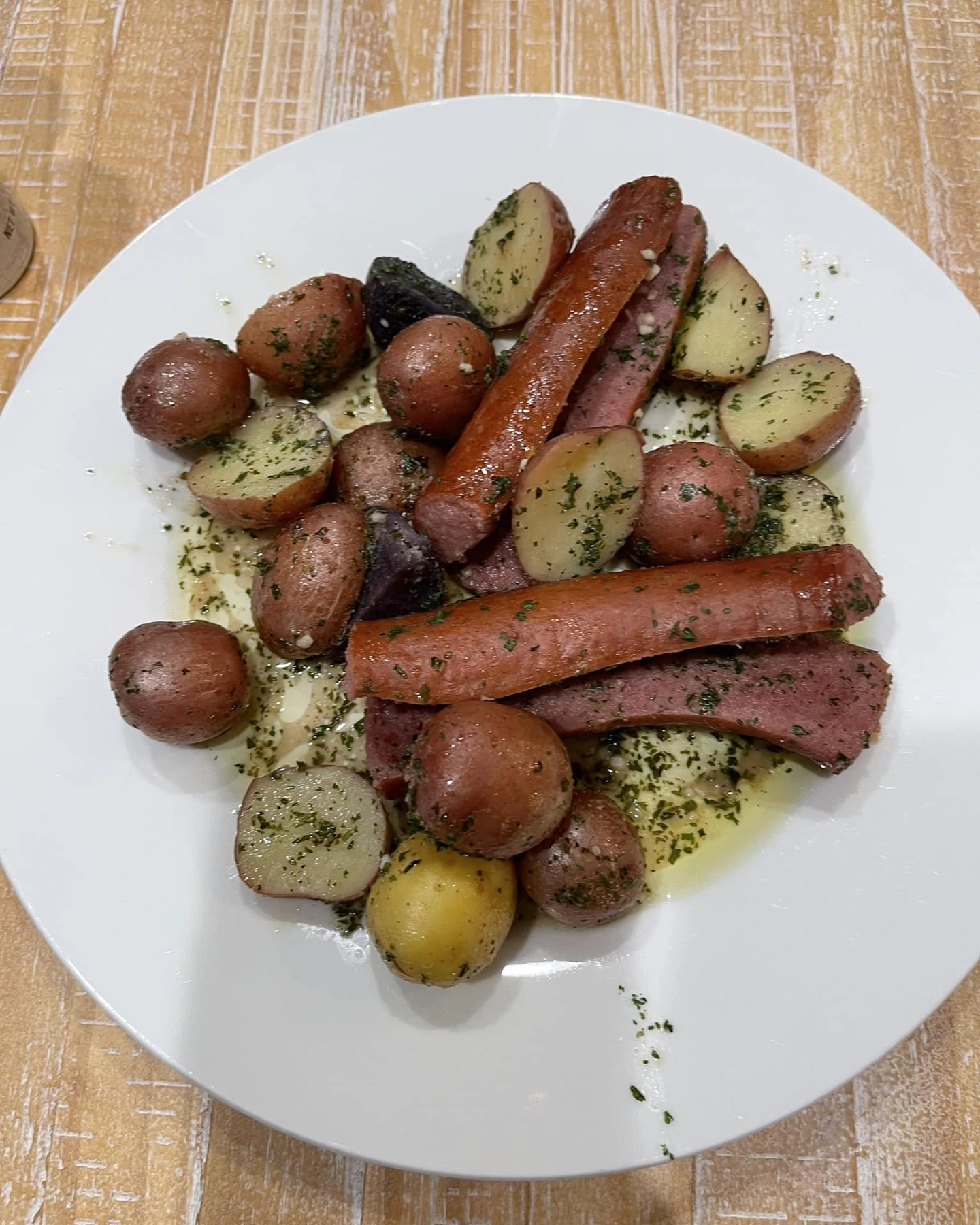 Cooked sausage and herbed potatoes served from foil pouches