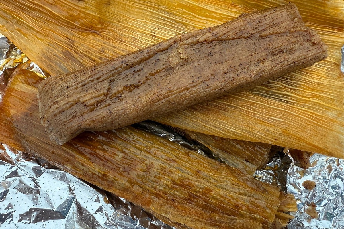 An unwrapped Delta-style tamale on its corn husk at Solly’s in Vicksburg