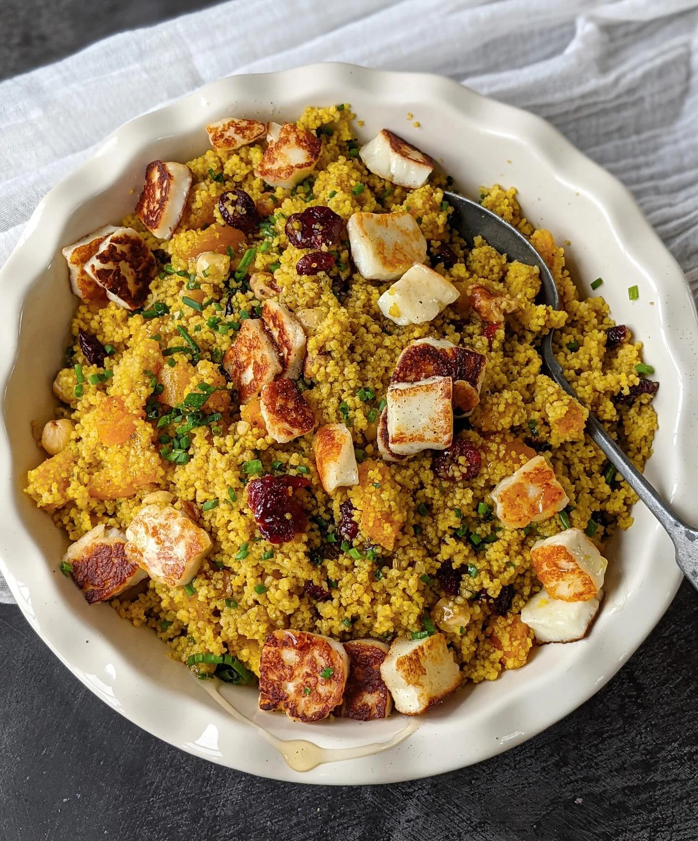 Golden couscous with dried apricots, cranberries, nuts and browned halloumi