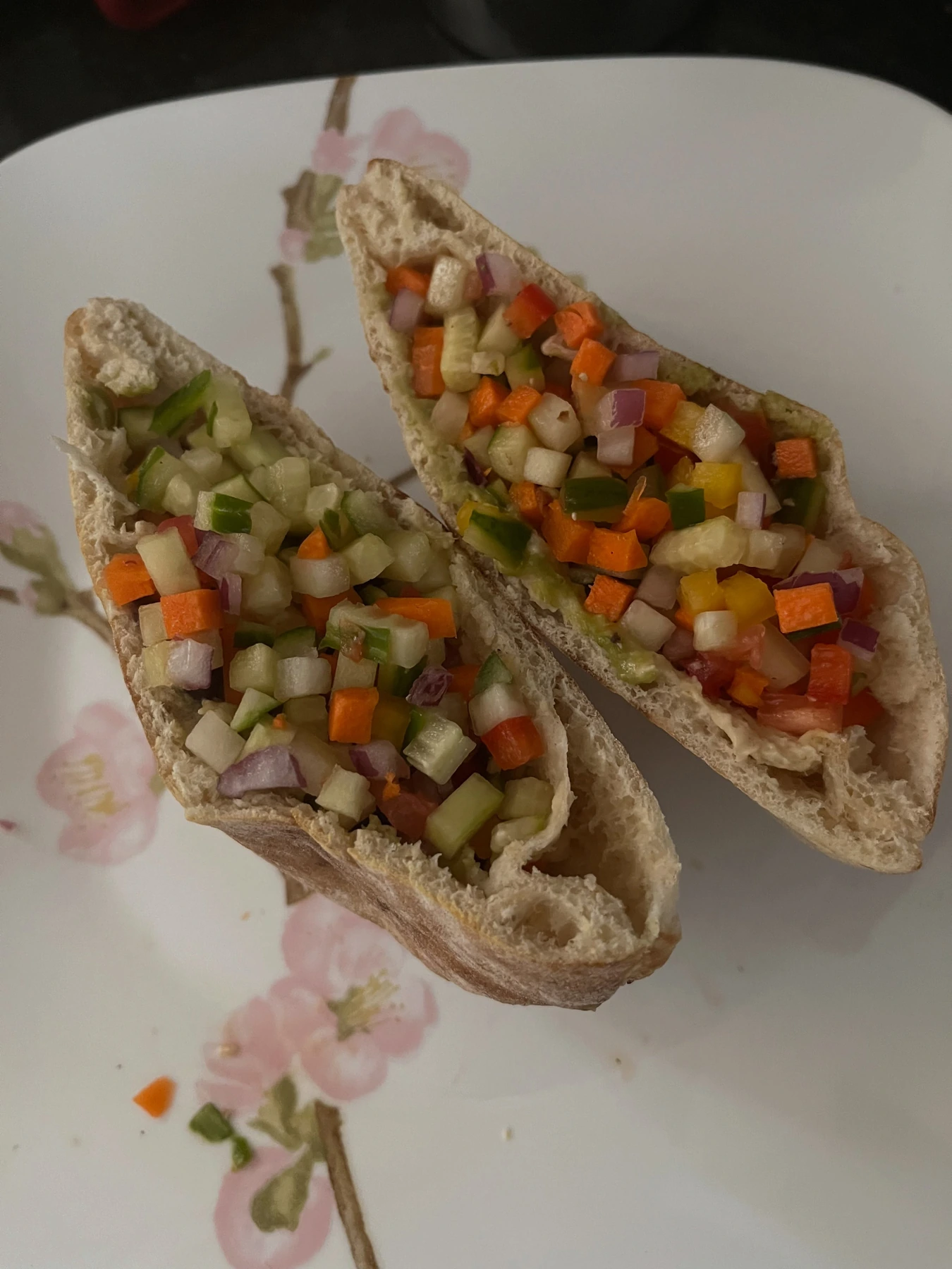 Whole-wheat pita pockets stuffed with diced vegetables and hummus
