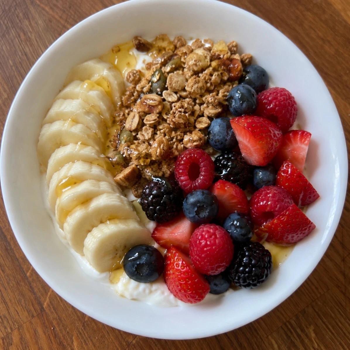 Yogurt bowl with banana, mixed berries and crunchy granola