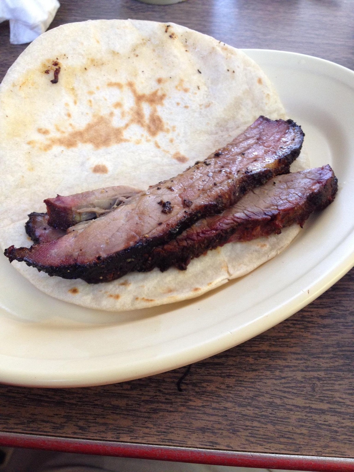 Sliced brisket on a flour tortilla at Garcia’s Mexican Food