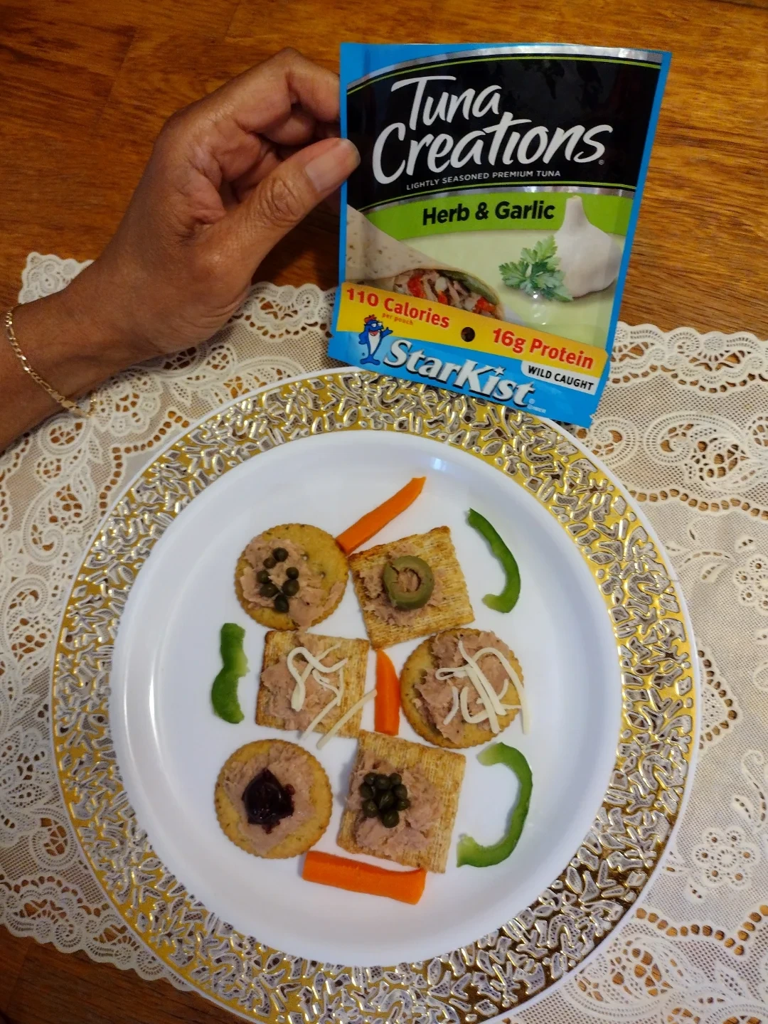 Tuna pouch beside crackers topped with tuna and vegetables