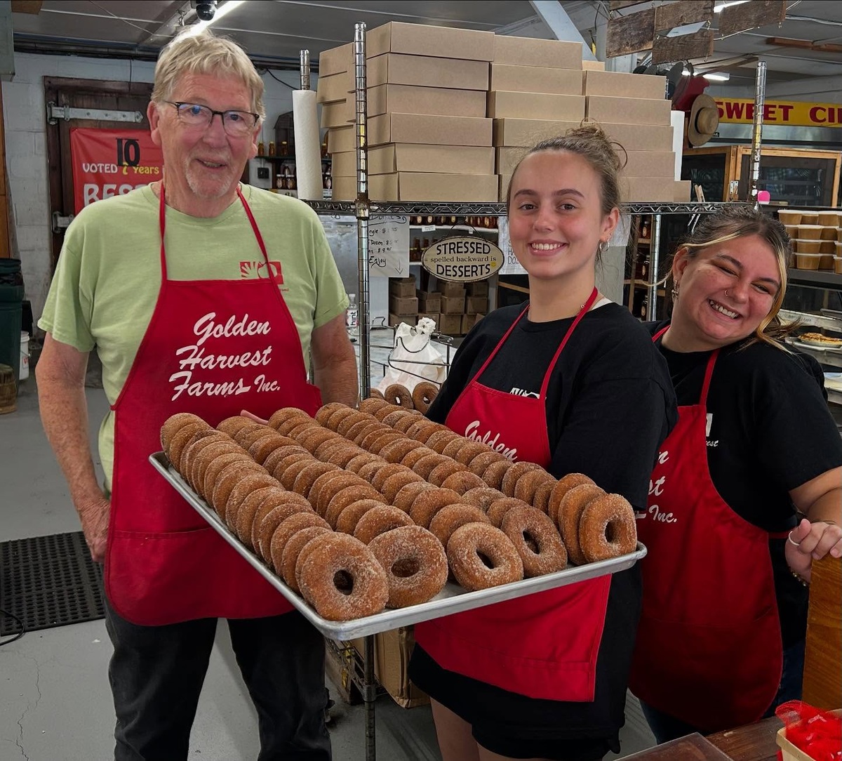 The Golden Harvest Farms team with a tray of cider donuts