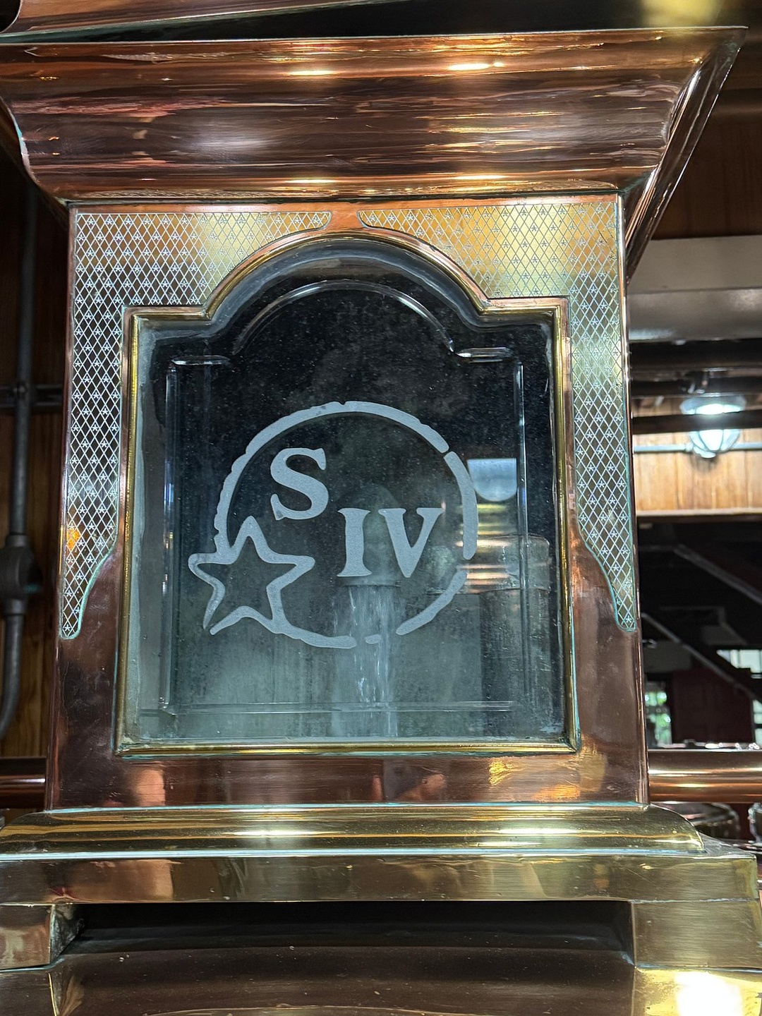 Copper equipment with the Maker’s Mark star emblem inside the Loretto distillery