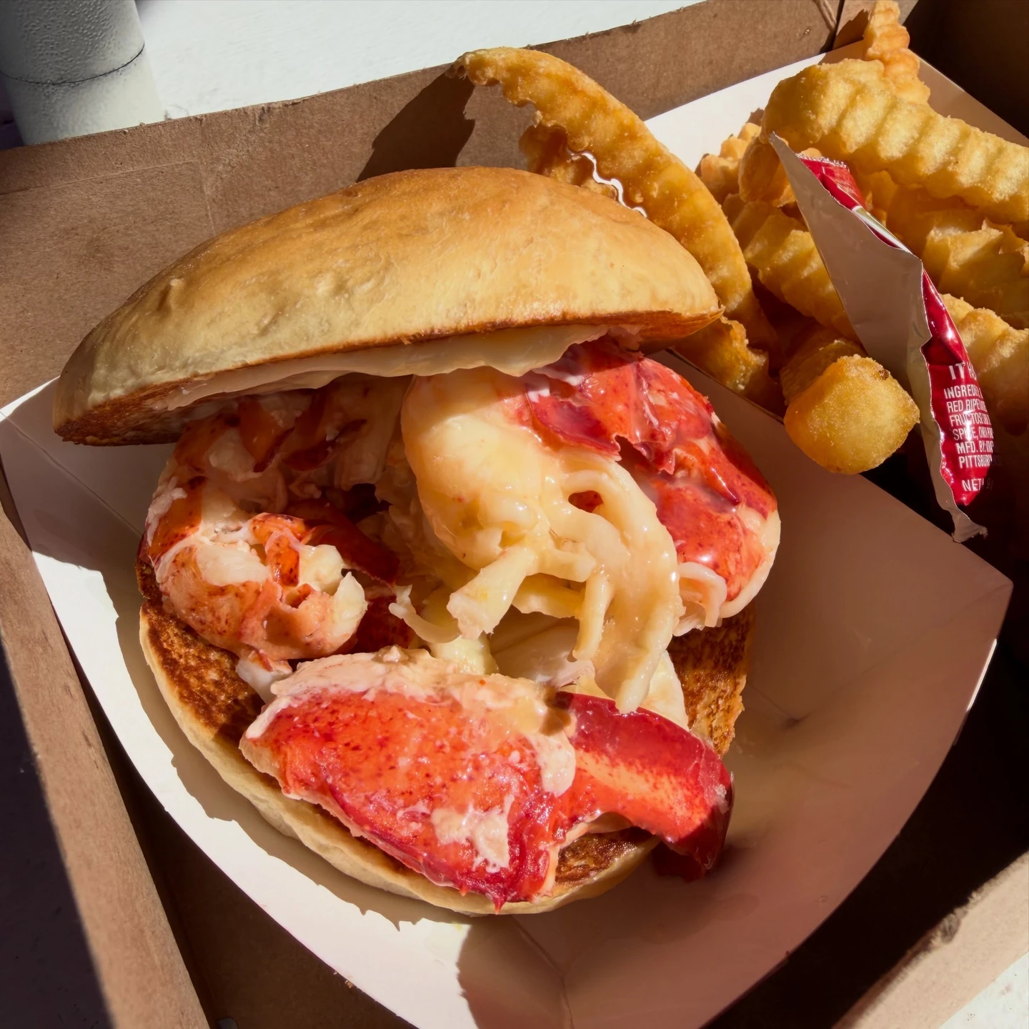 Large lobster pieces in the Clam Shack’s round bun, with crinkle-cut fries