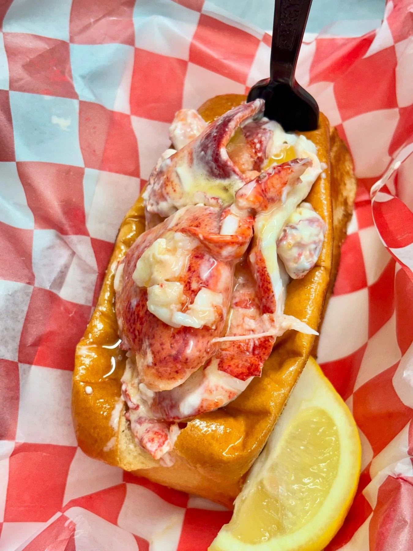 Footbridge Lobster roll in a red checkered basket with lemon