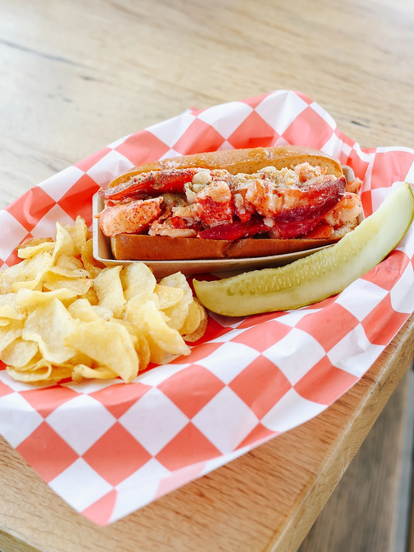 Luke’s Portland Pier lobster roll with potato chips and a pickle