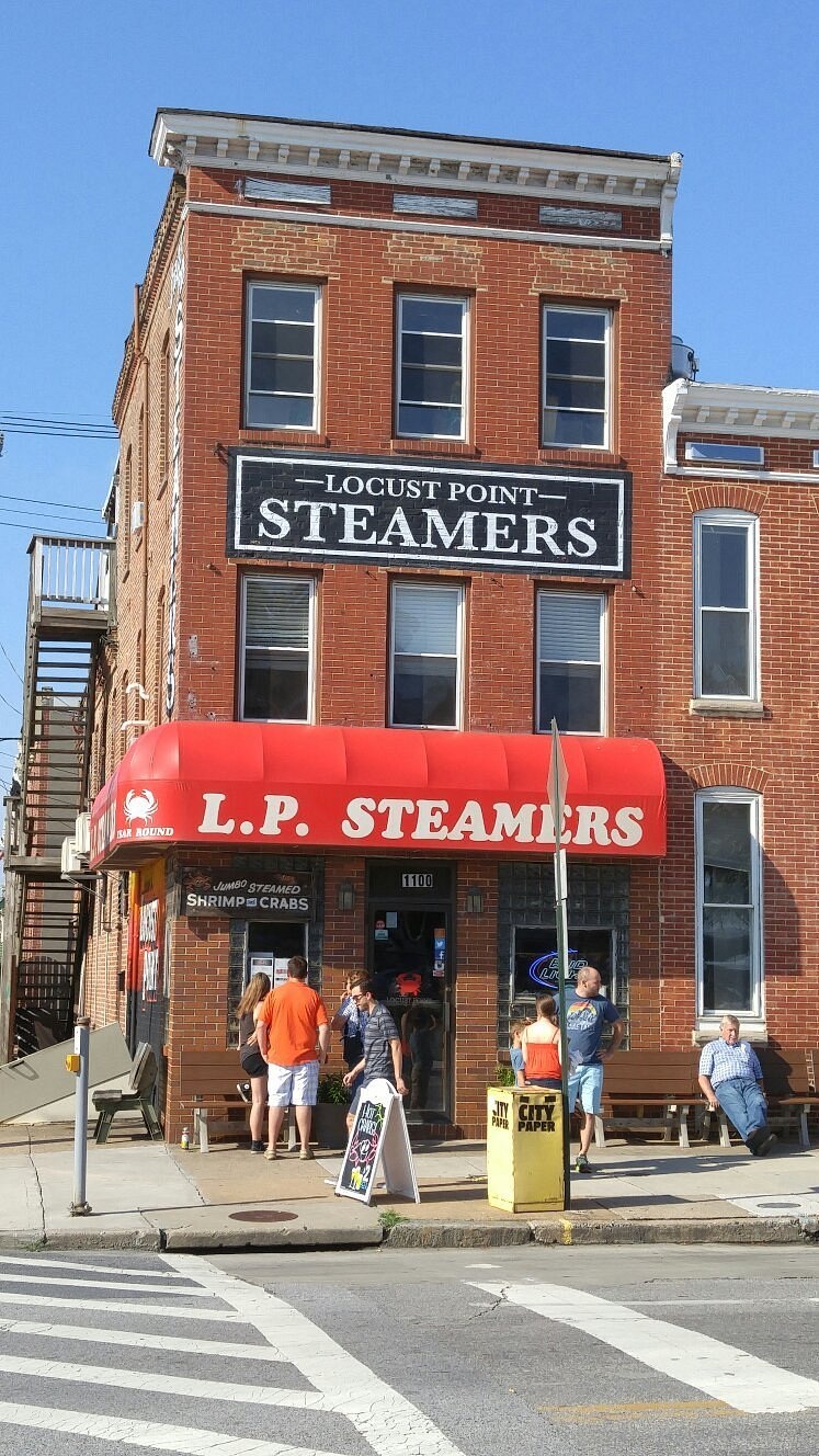 Brick exterior and red awning of LP Steamers in Baltimore
