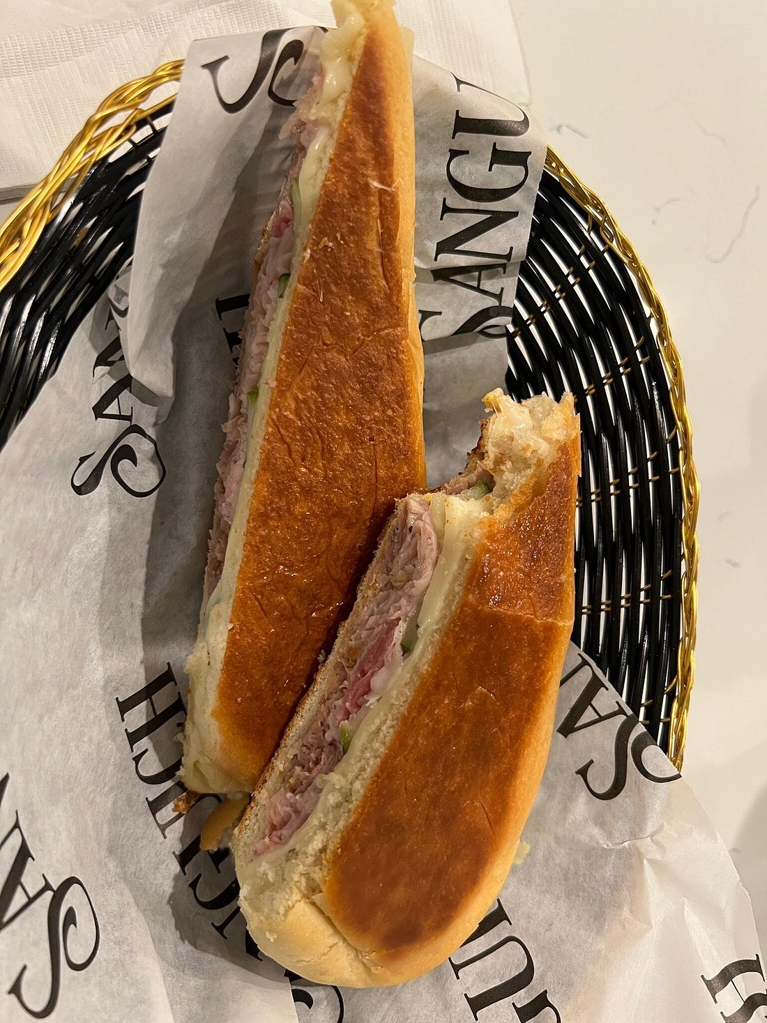 A medianoche sandwich photographed at Sanguich