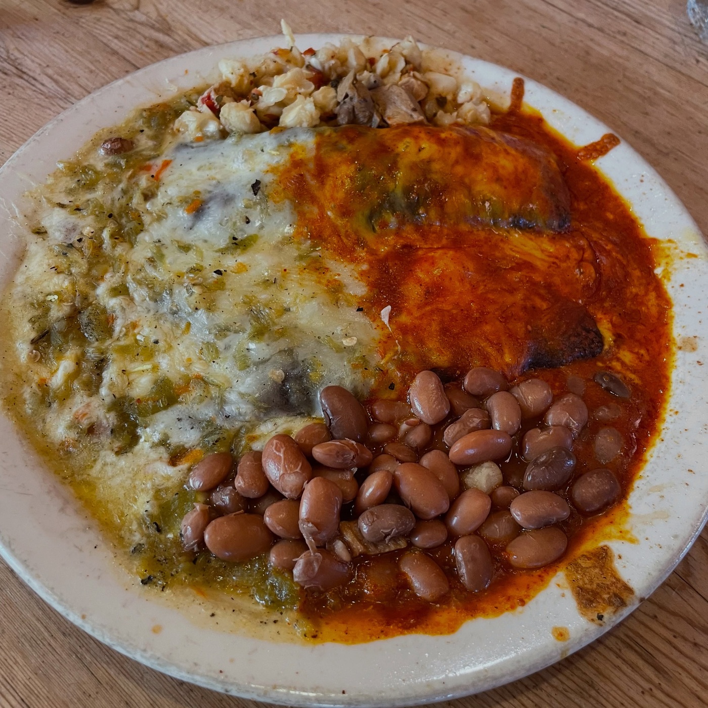 Plate with red and green chile, beans and posole at La Choza