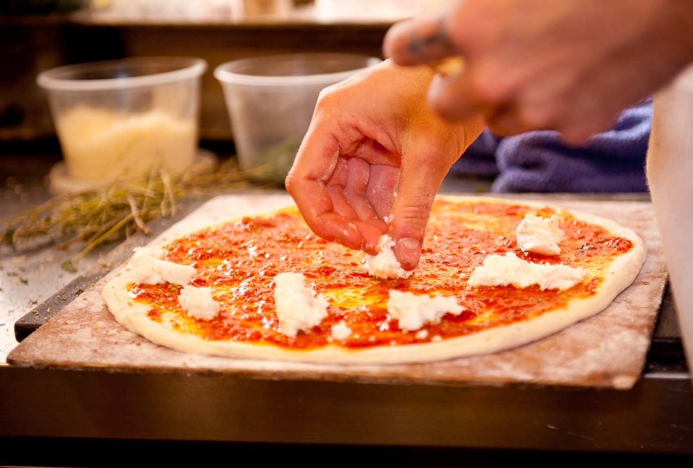 Preparing pizza at Gathering Together Farm