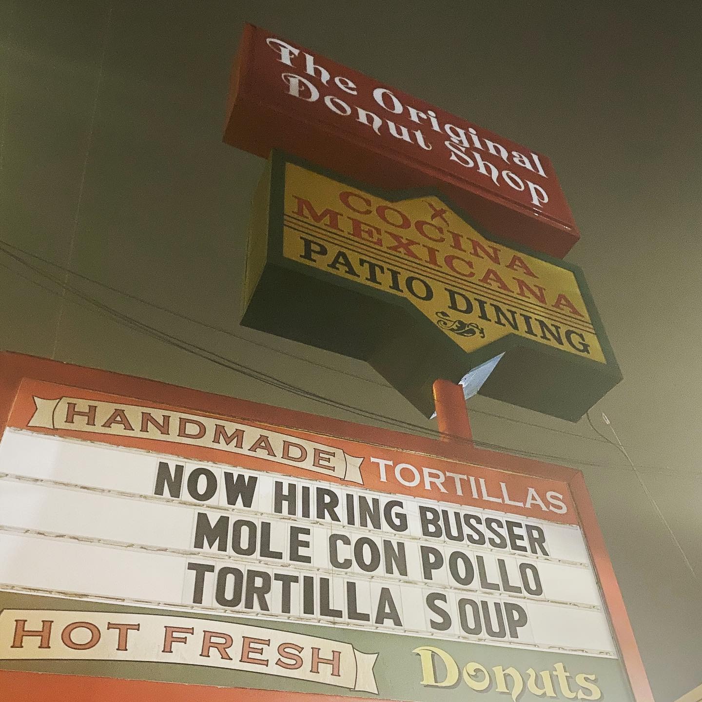 The Original Donut Shop roadside sign advertising tacos and handmade tortillas
