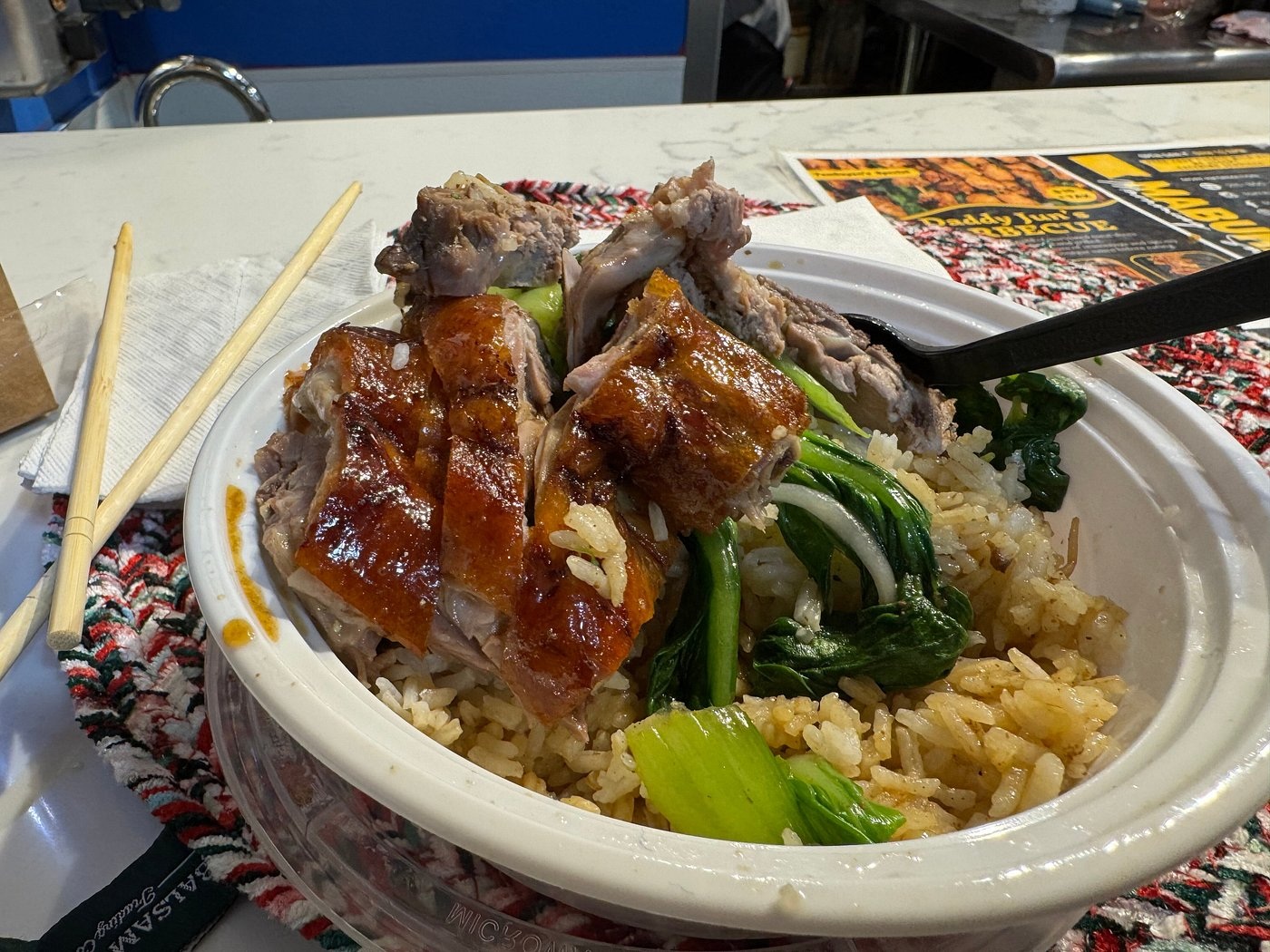 Roast duck with rice and greens at Sang Kee’s Reading Terminal Market counter