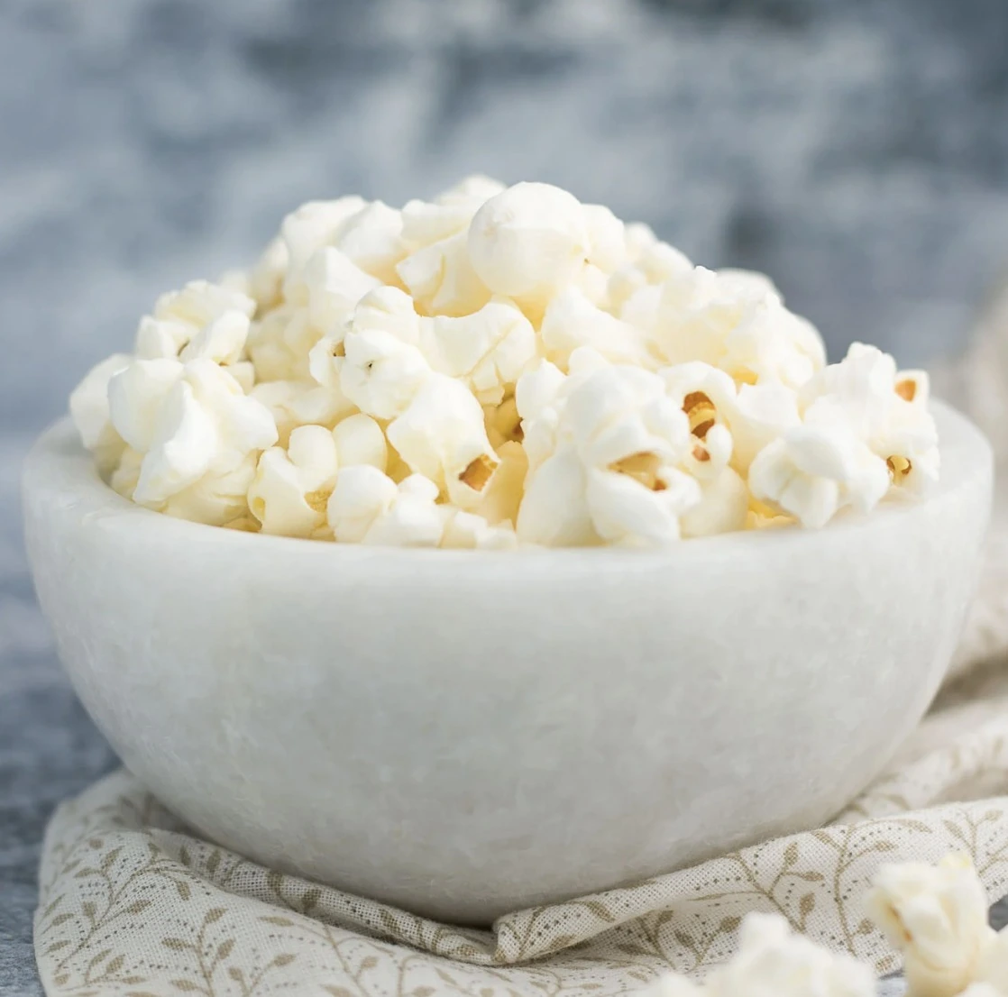 Fresh popcorn in a white ceramic bowl