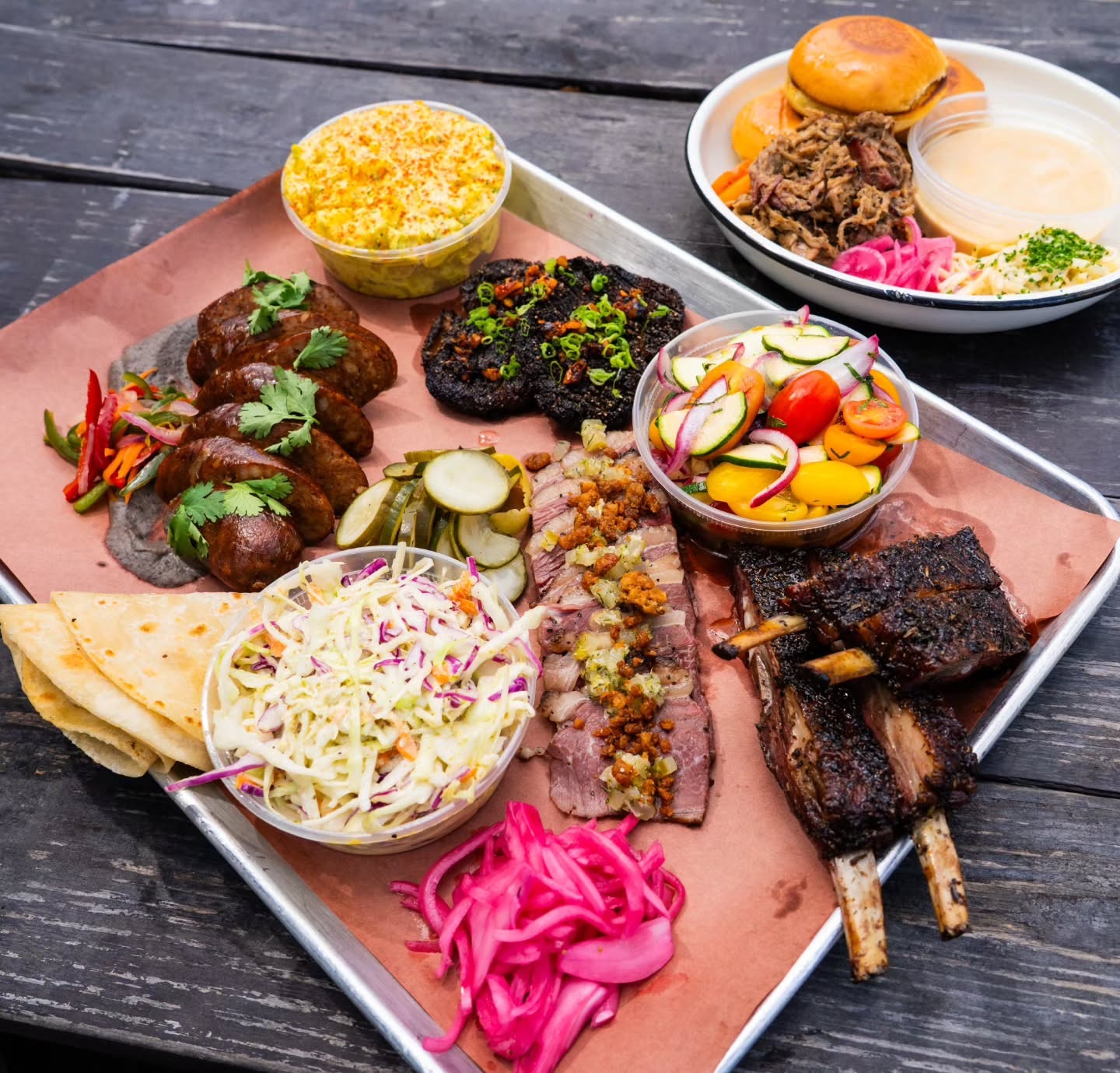 A tray of smoked meats and sides at InterStellar BBQ