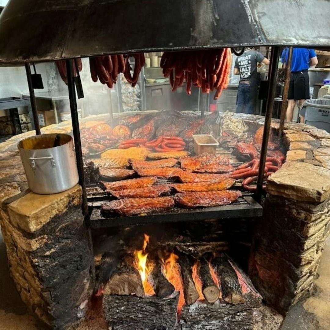 Meats cooking over the open pit at The Salt Lick