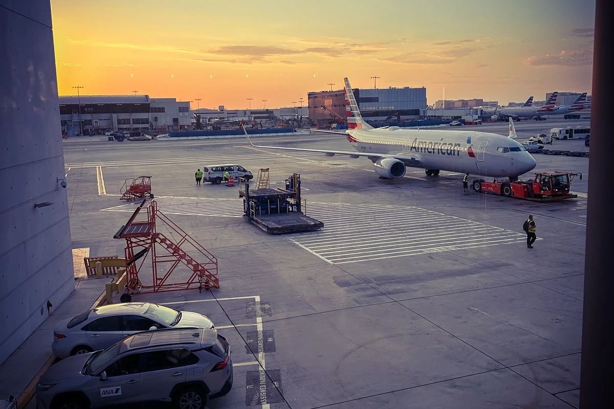 Passenger aircraft at an airport gate at sunrise