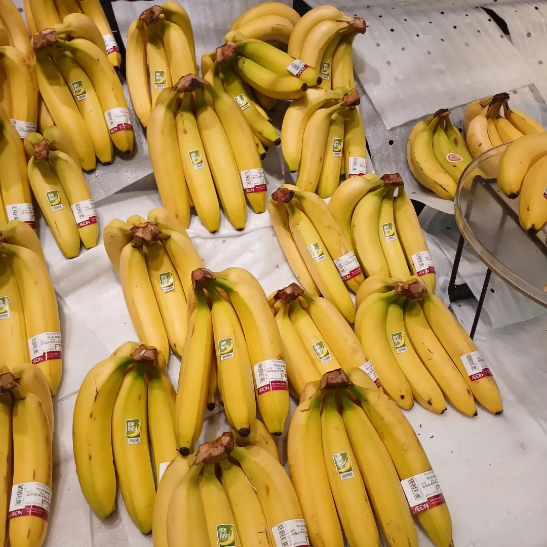 Bunches of ripe yellow bananas at a market