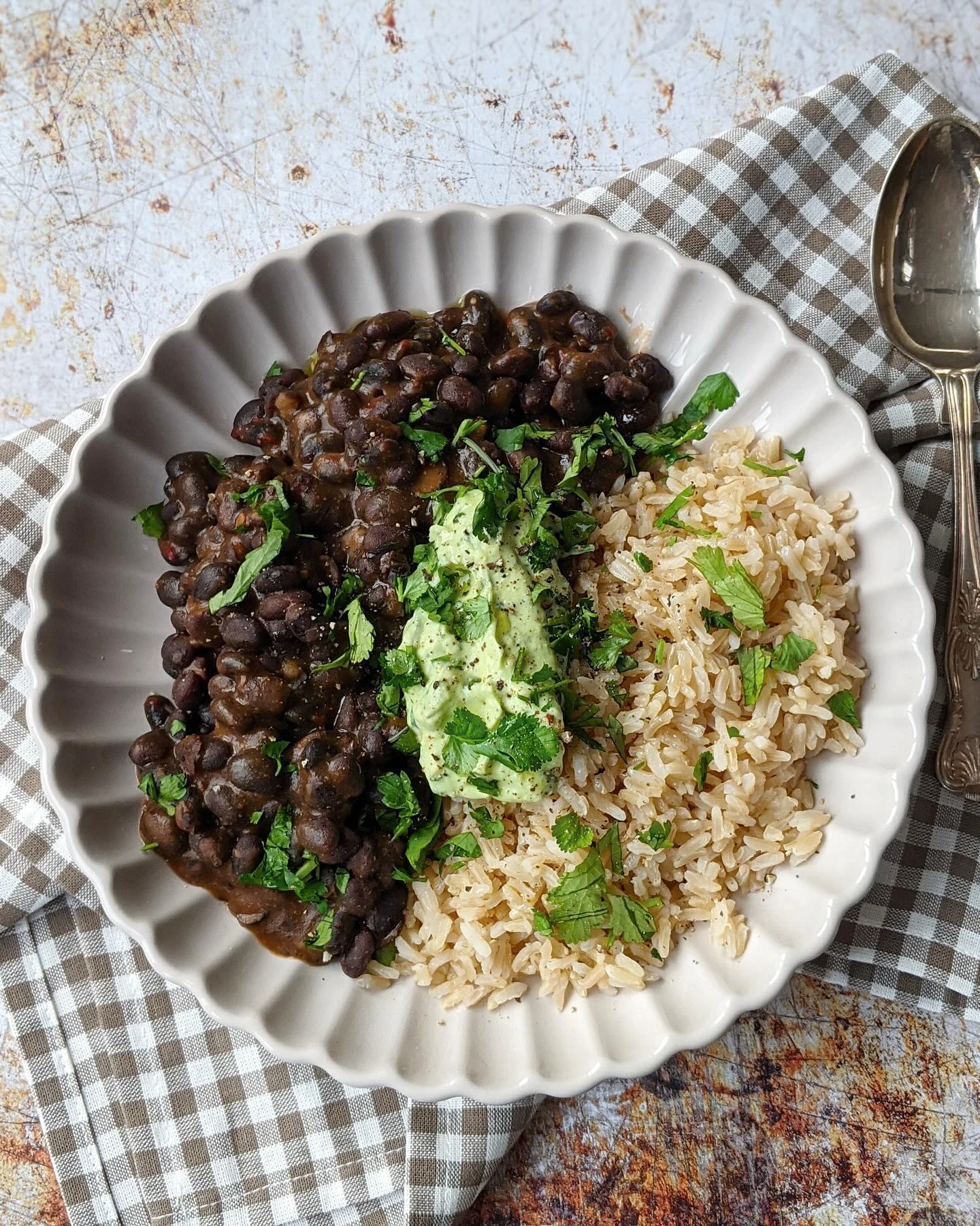 Black beans and rice with avocado crema and chopped coriander