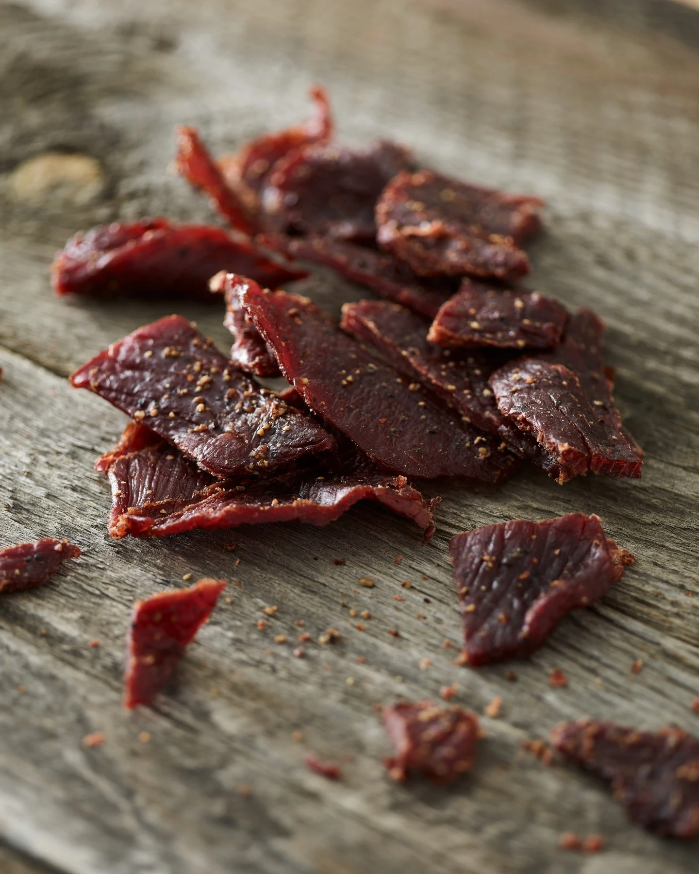 Beef jerky strips on a wooden surface