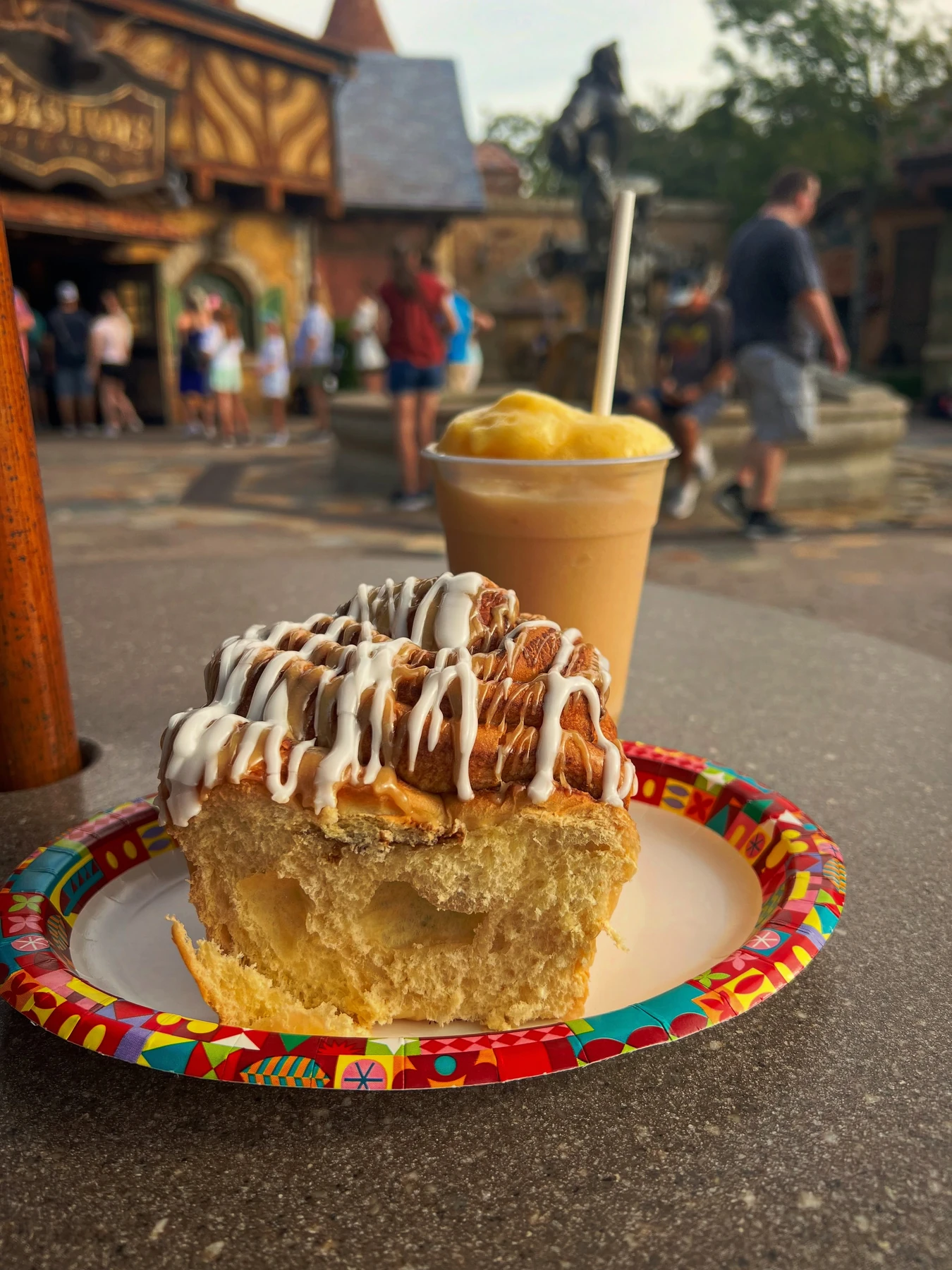 Large iced cinnamon roll with a frozen drink at Gaston’s Tavern