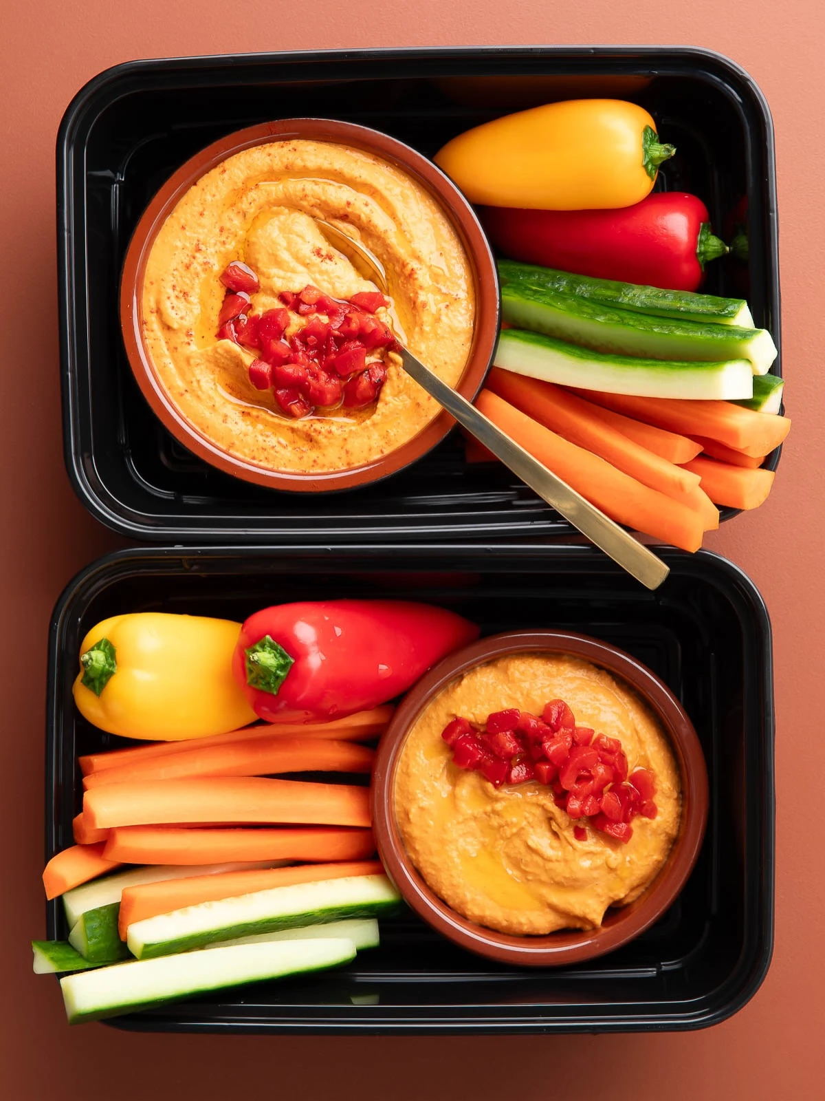 Snack boxes with hummus, cucumber sticks, carrots and sweet peppers