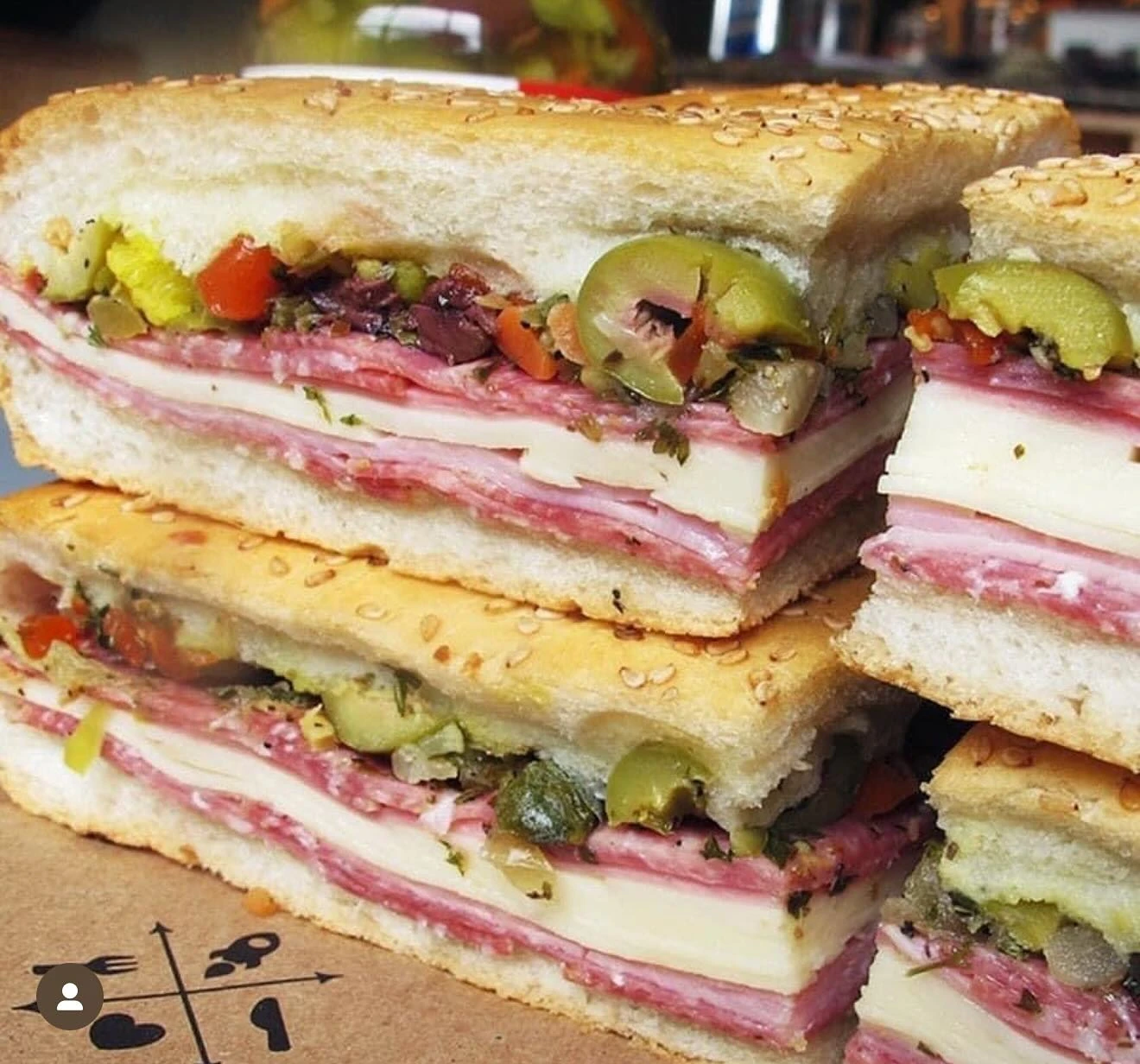 Central Grocery muffuletta wedges layered with cured meats, cheese, and olive salad