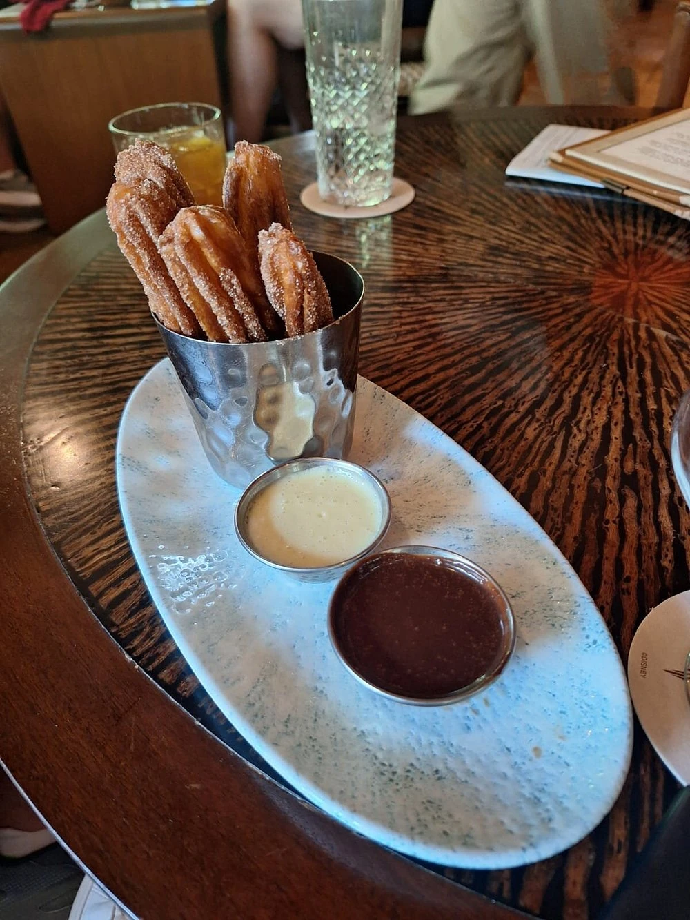 Cinnamon-sugar churros with two dipping sauces at Nomad Lounge