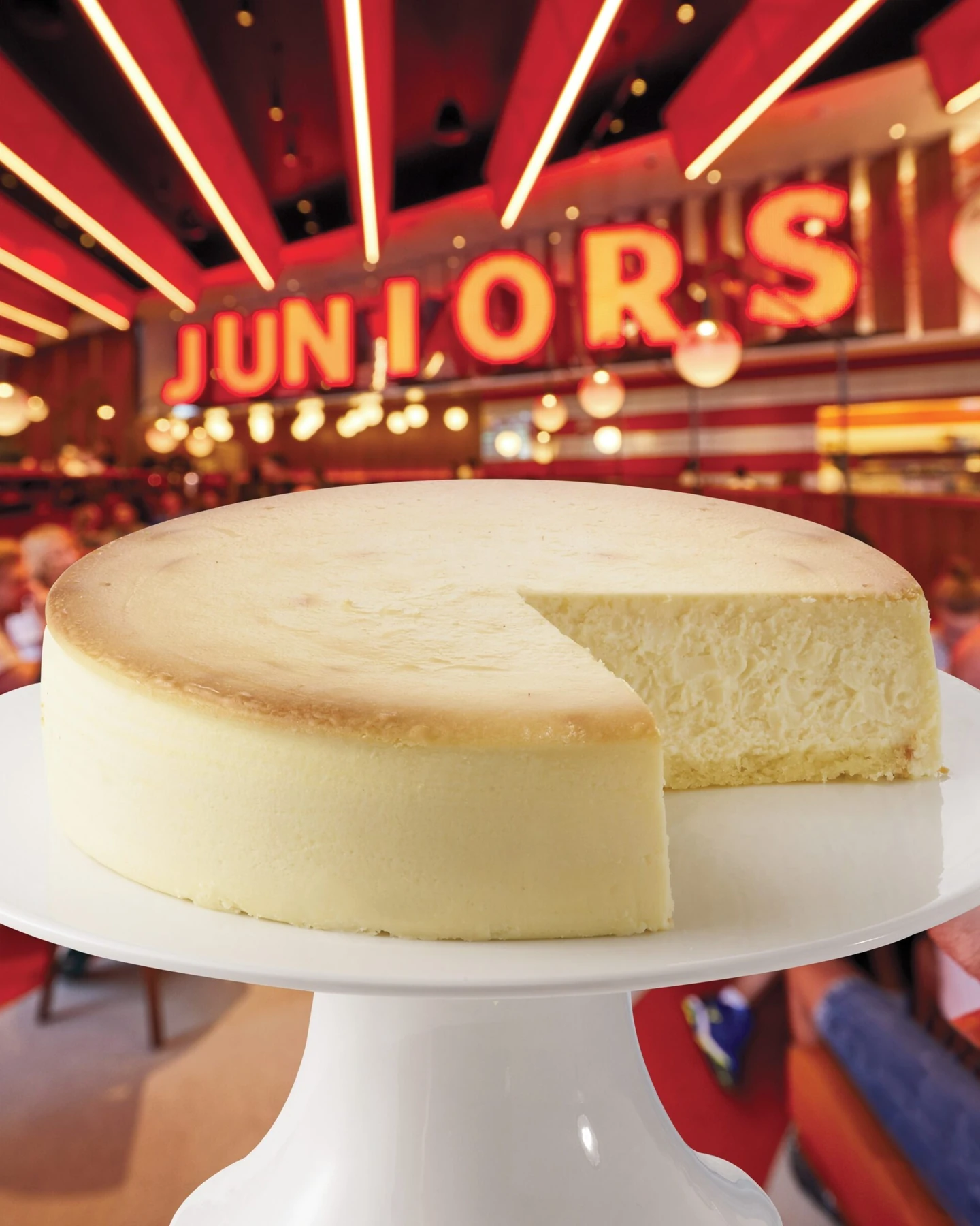 Classic New York cheesecake with a slice removed at Junior’s
