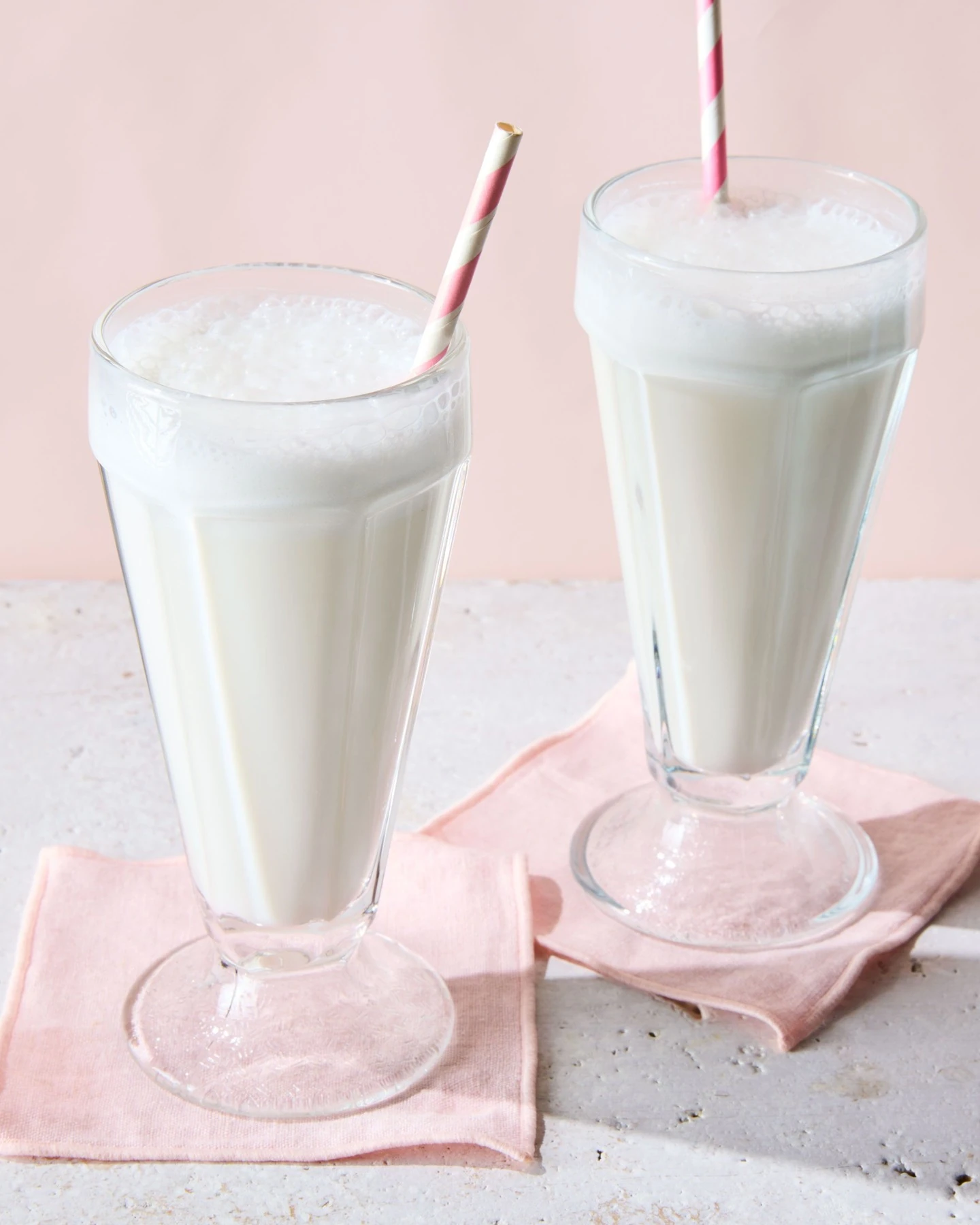 Two foamy egg creams made with milk, flavored syrup and seltzer