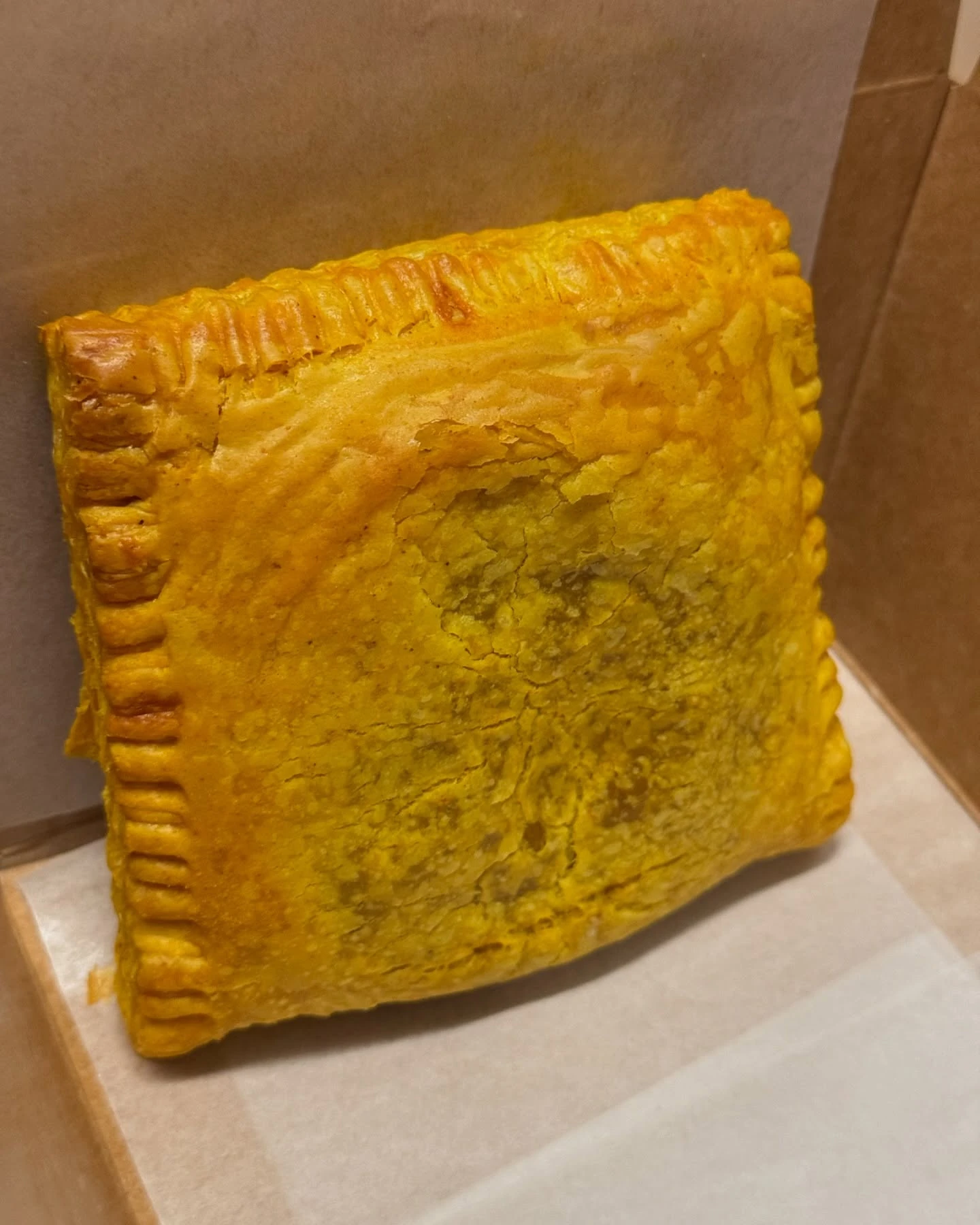 Golden flaky Jamaican patty from Tosh’s Patties in Brooklyn