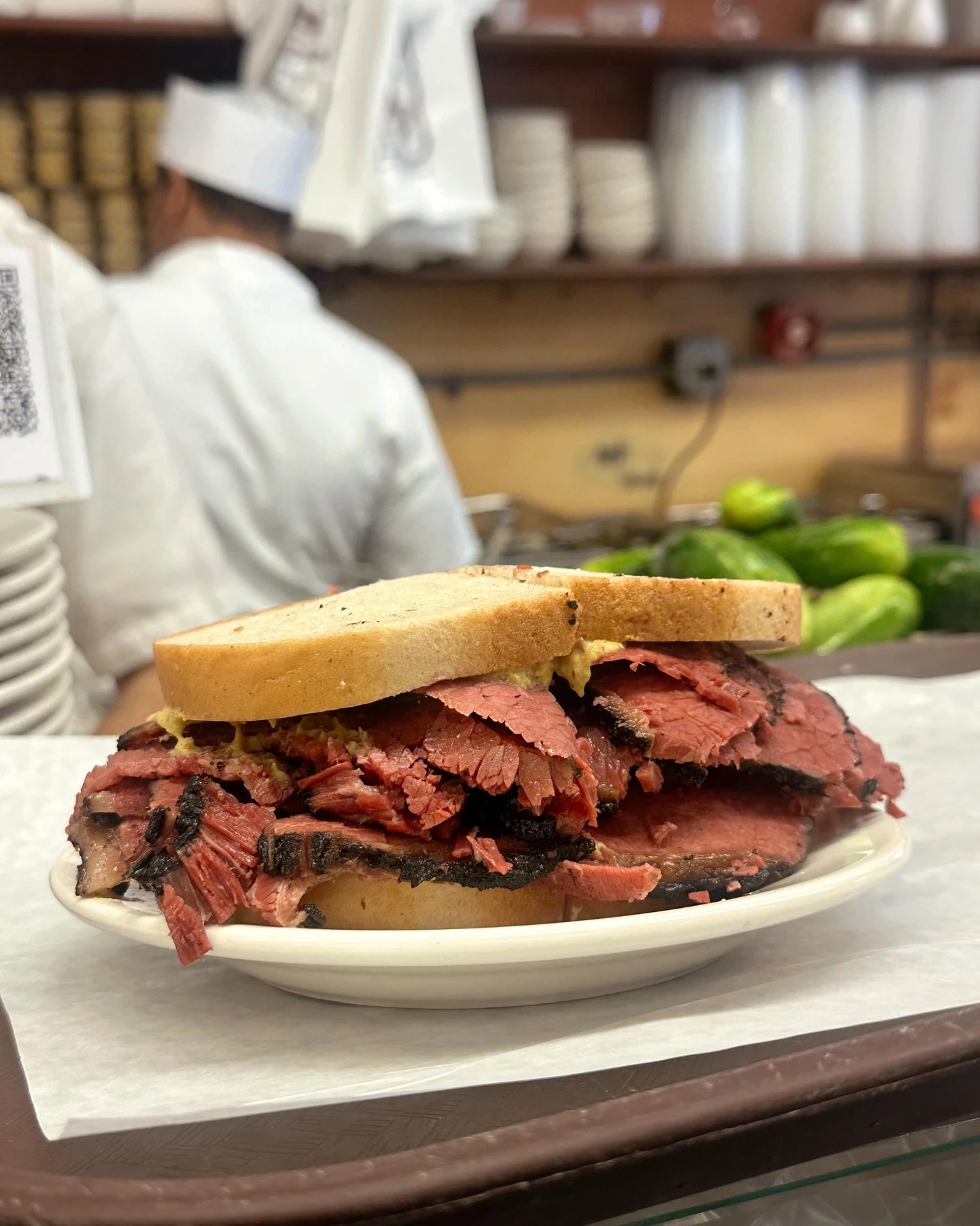 Thick-cut pastrami stacked on rye bread at Katz’s Delicatessen in New York