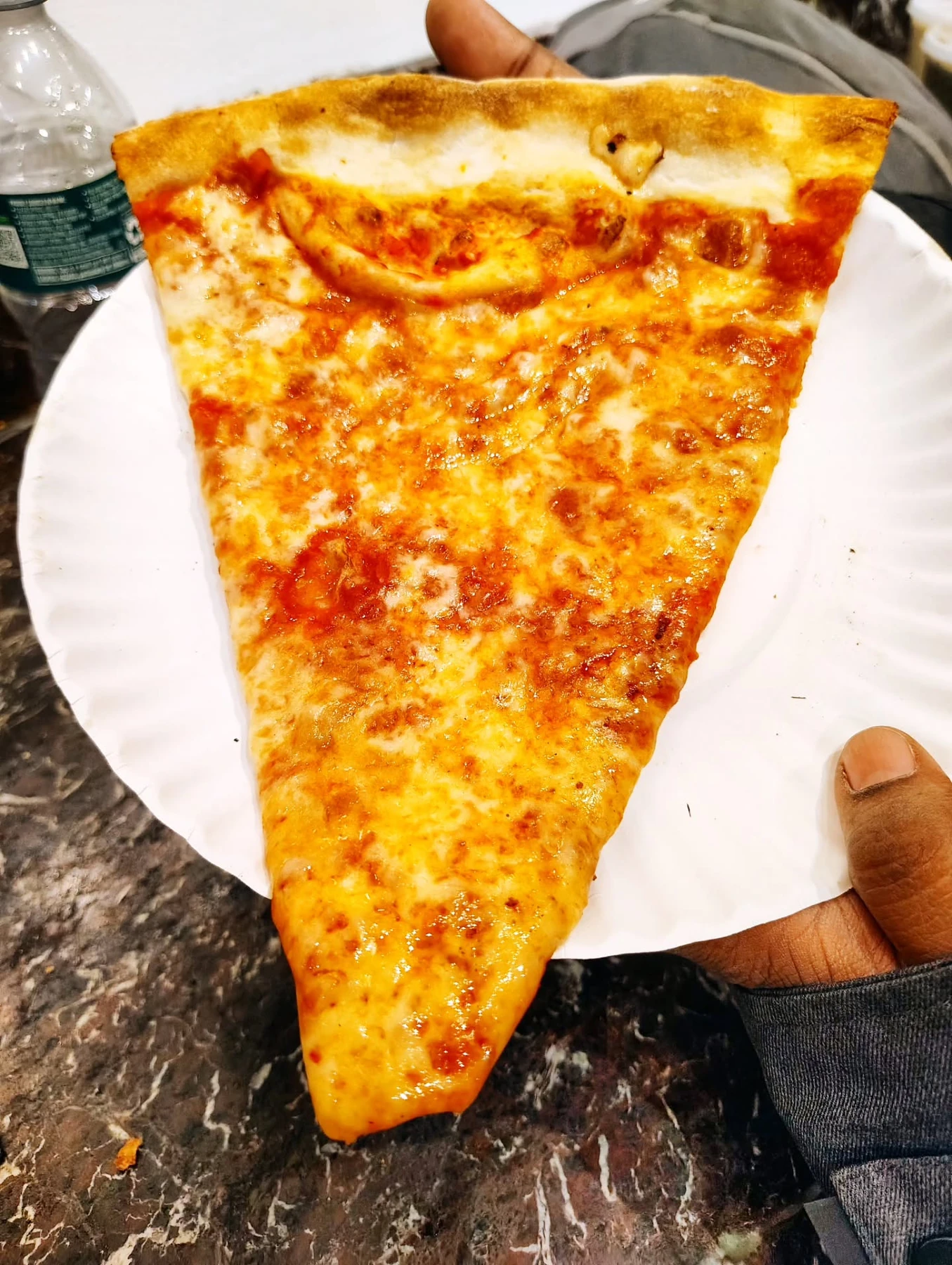 Thin-crust cheese pizza slice from Joe’s Pizza in New York