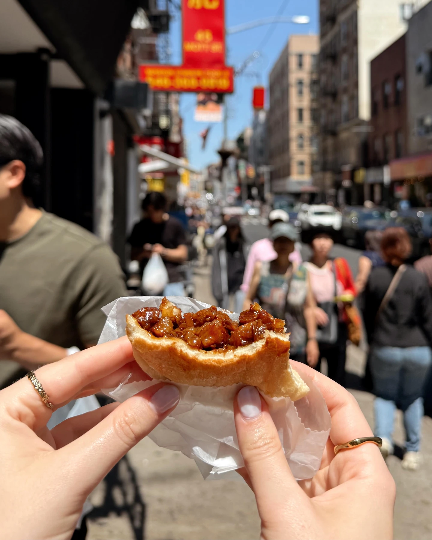 Baked roast pork bun showing its glossy pork filling in New York’s Chinatown