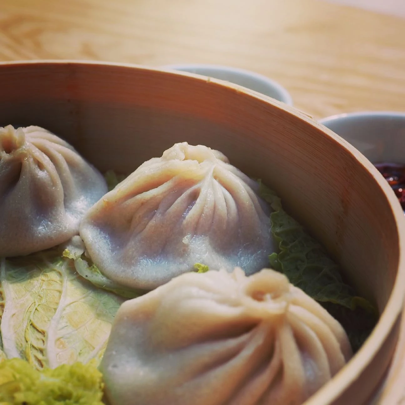 Soup dumplings in a bamboo steamer at Joe’s Home of Soup Dumpling in New York
