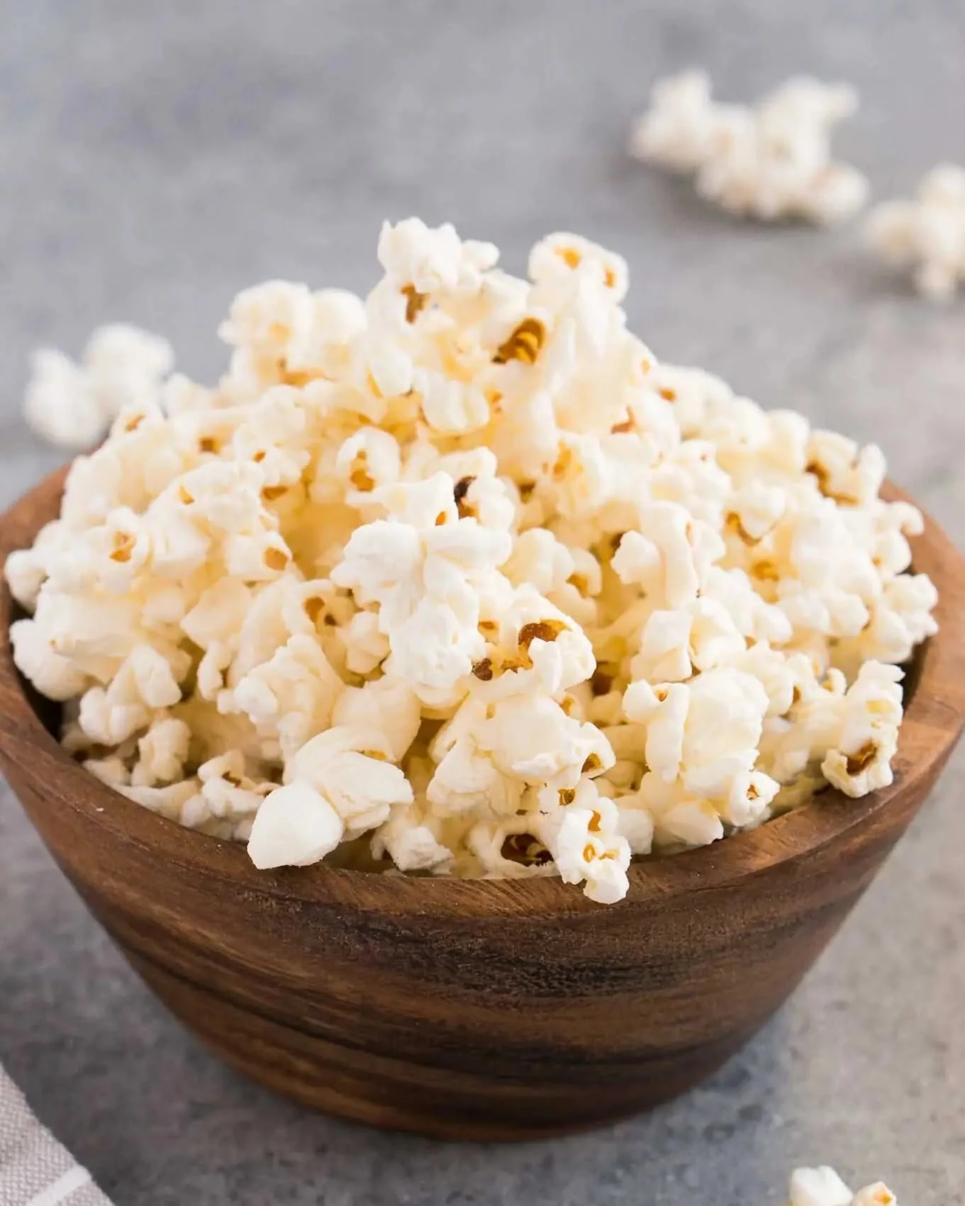 Plain popcorn piled in a wooden bowl