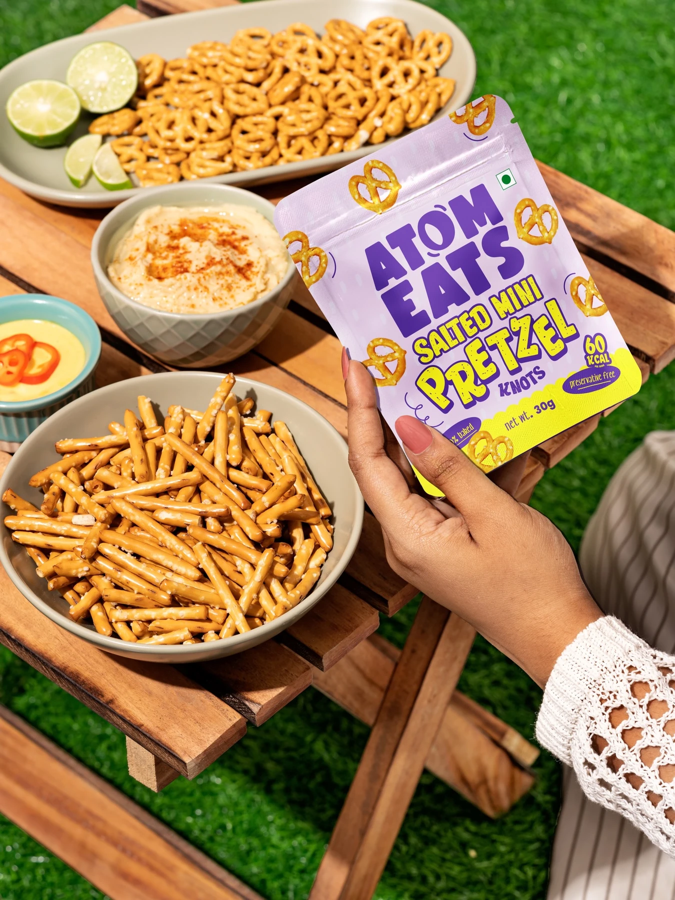 Mini pretzel twists and pretzel sticks on a picnic table